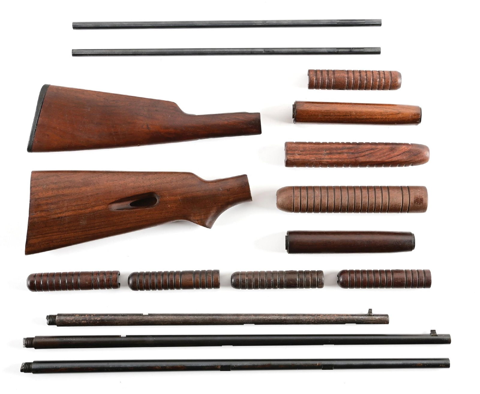 WINCHESTER .22 LOT OF (2)BARRELS, (2)STOCKS (9) FOREARMS AND (2) TUBES.: Lot includes a Model 63 stock and a Model 61/62 stock with black Winchester butt plate in excellent condition showing minor impressions and finish loss. Includes two blued loading tubes in near mint c