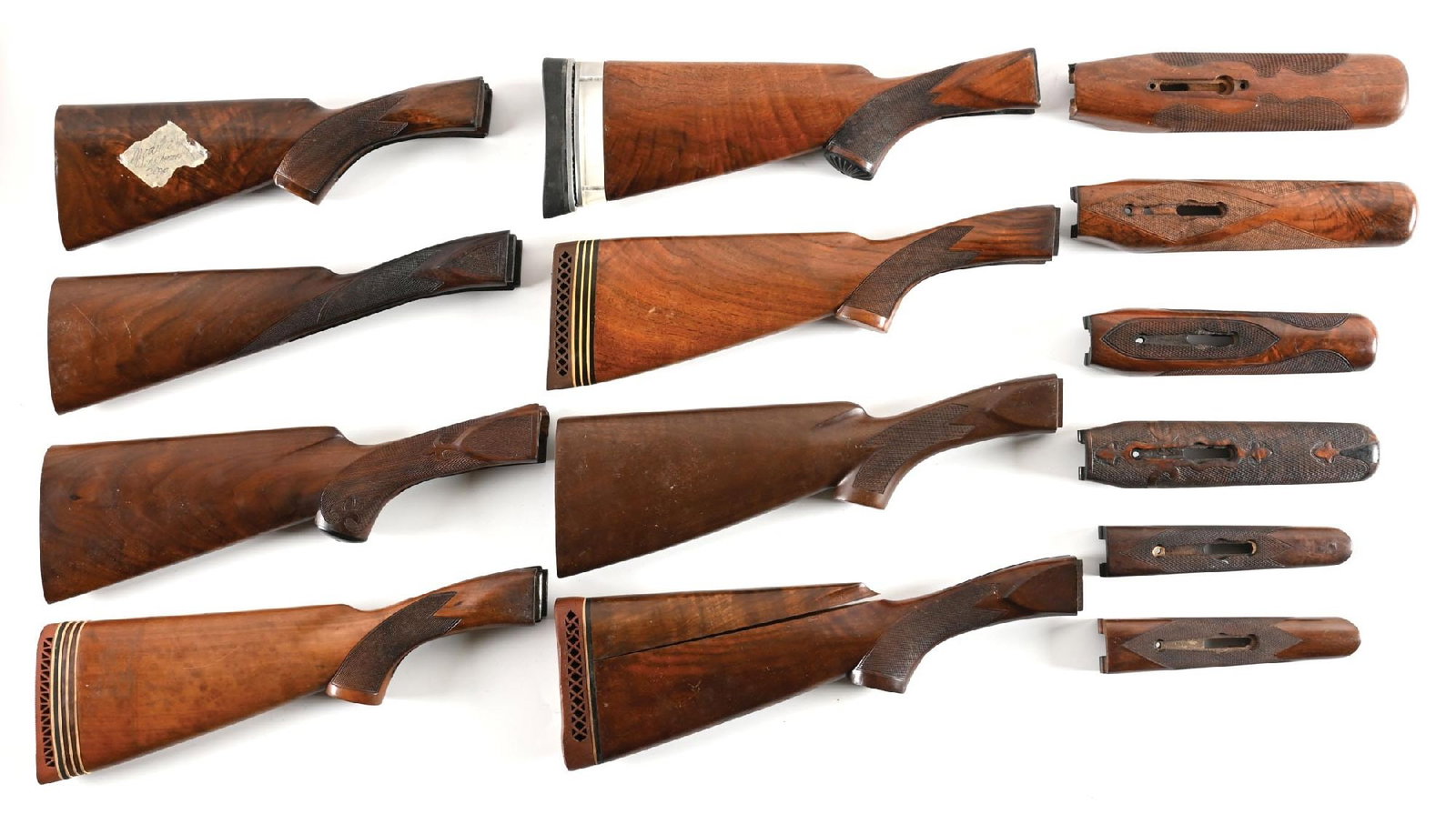 LOT OF (7) WINCHESTER MODEL 21 SHOTGUN STOCKS AND (5) FOREARMS.: This lot of fantastic Winchester wood consists of three checkered pistol grip stocks, two checkered pistol grip stocks with added recoil pads, one checkered English style straight grip stock and one c