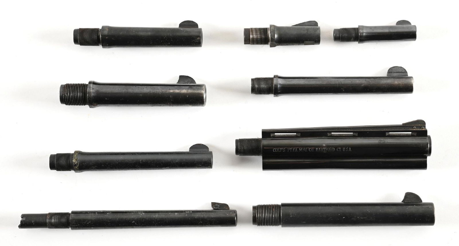 LOT OF (9) COLT REVOLVER BARRELS.: A. Blued 4 1/2" New Service 38-40. Tapered barrel, two line barrel address, full front sight, 95% blue with bright bore. B. Blued .38 5" Police Positive 95% blue with bright bore. C. Blued 32-20 Offic