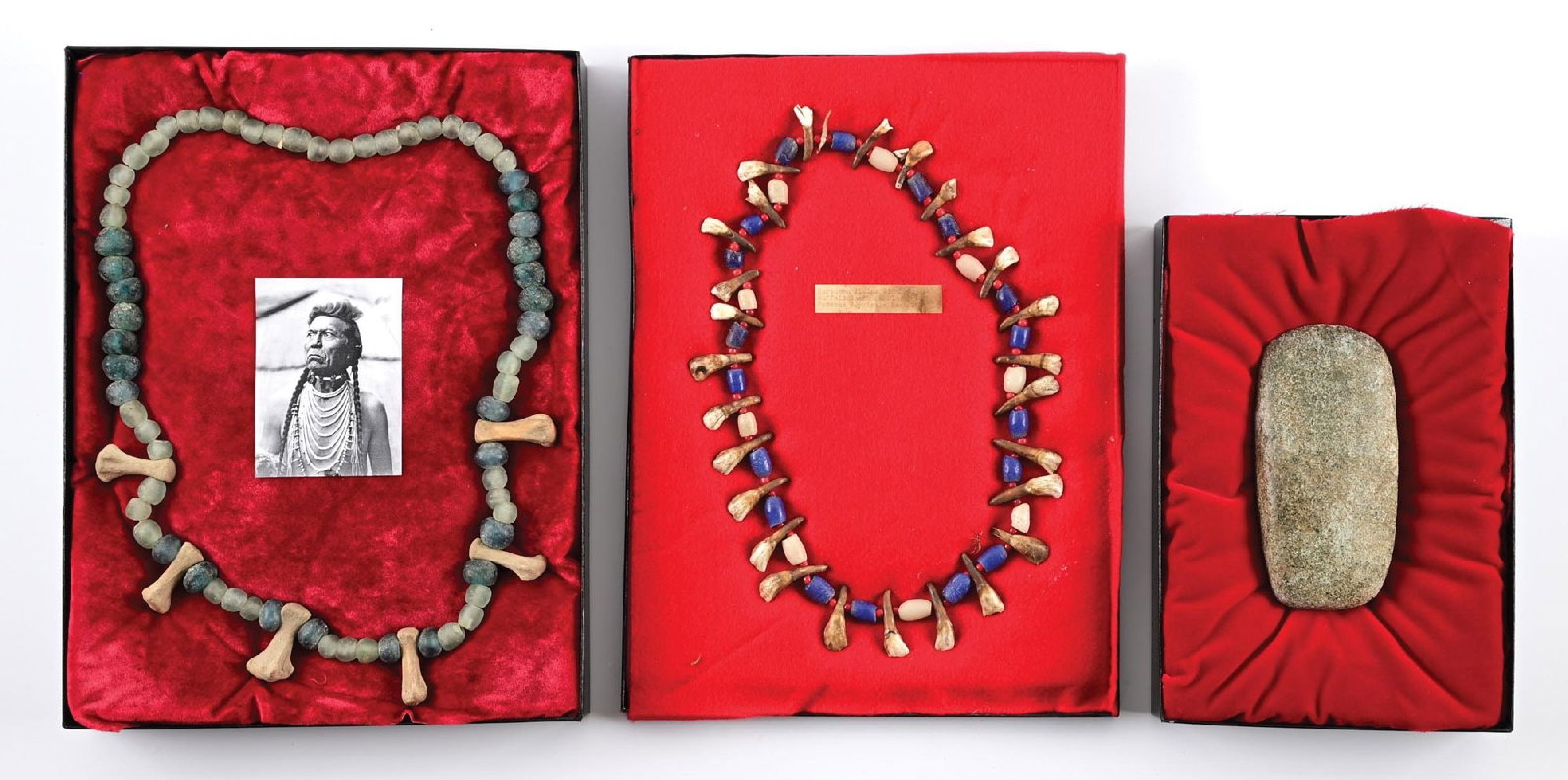 LOT OF 3: NATIVE AMERICAN NECKLACES AND STONE AXE.: Lot consists of: (A) Framed riker of large cobalt and milk glass made bead necklace separated by bison teeth and large white centered rose trade beads. (B) Riker of large blown glass blue and clear