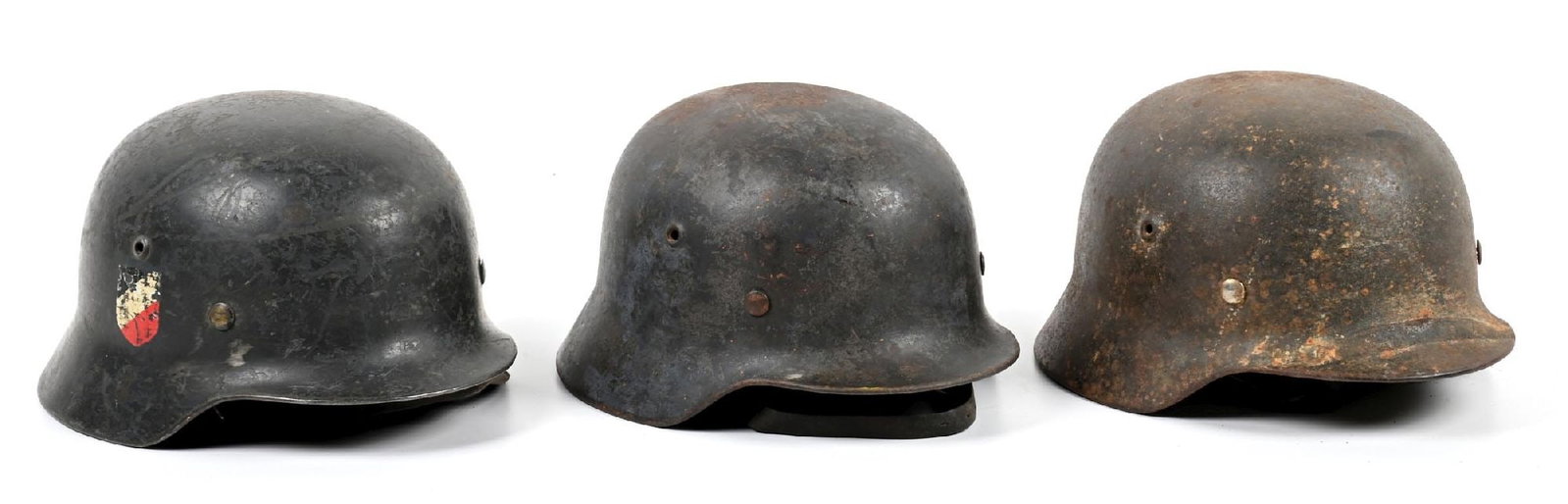 LOT OF 3: GERMAN WWII M35 AND M40 LUFTWAFFE HELMETS.: Lot of 3 German WWII Luftwaffe helmets: (A) Luftwaffe M35 with both decals dug out and with little remaining. Was repainted with a darker blue-gray and both the original M35 paint and the repaint