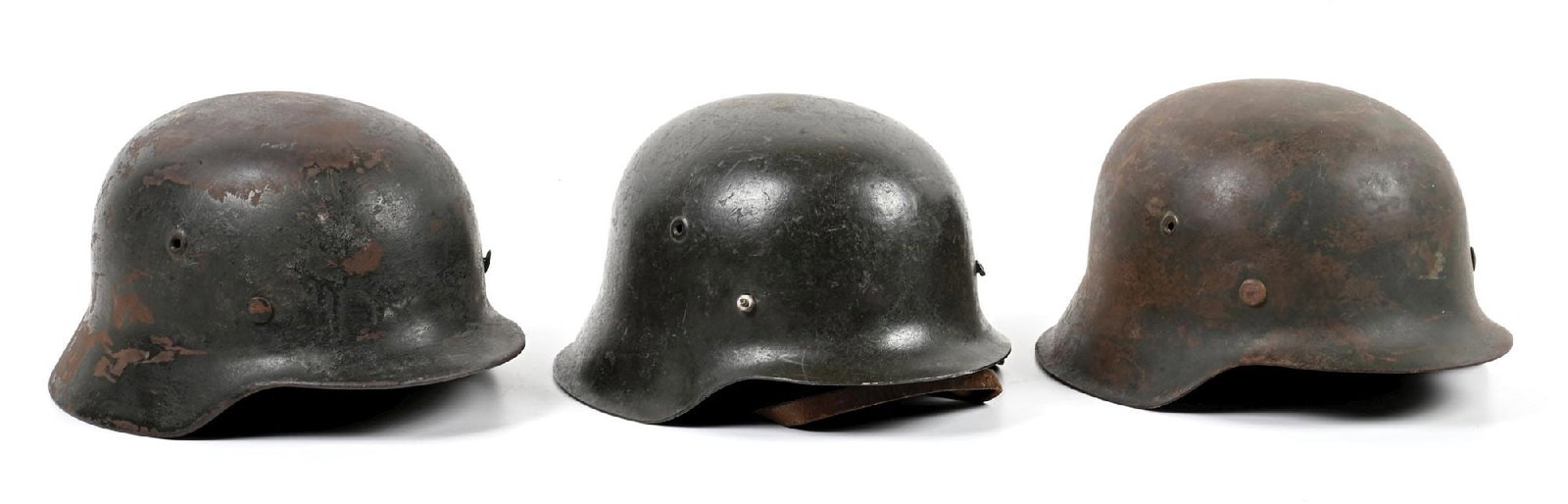 LOT OF 3: GERMAN WWII HEER M40 AND M42 HELMETS.: Lot of 3 German WWII Heer helmets: (A) Heer M40 with half of the decal remaining. Exterior is heavily damaged and covered with freckling. Interior retains half of its paint with freckling, and is