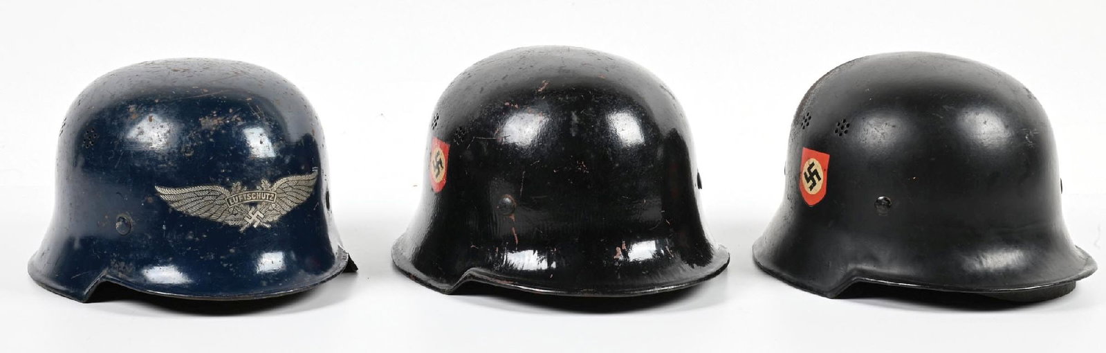 LOT OF 3: THIRD REICH M34 FIRE POLICE AND LUFTSCHUTZ HELMETS.: Lot contains 3 Third Reich M34 helmets: (A) M34 Fire Police helmet retaining almost all of its Polizei and Party decals with very light wear. Shell exterior and interior retain almost all of their