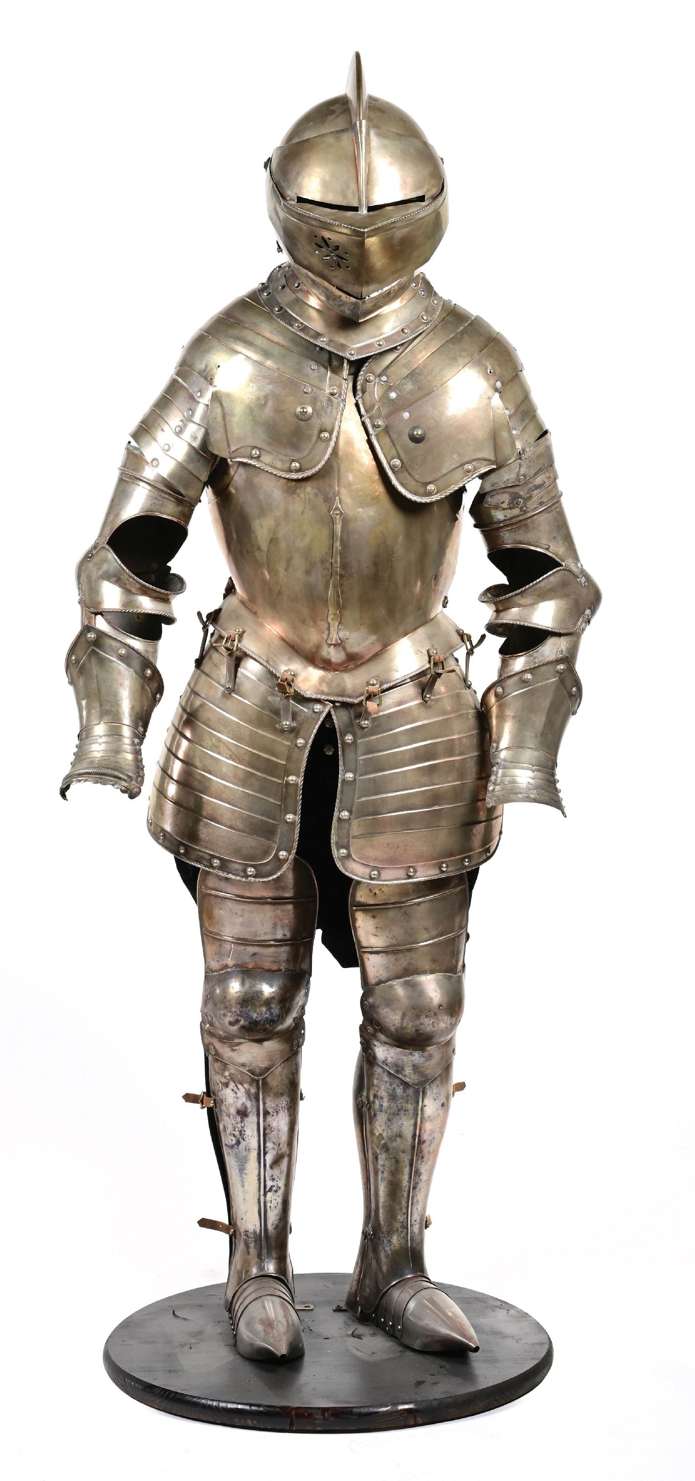 SUIT OF ARMOR.: Approximately 70" tall on stand. Made of a copper base that was subsequently flashed with silver (?, perhaps German silver). On attractive form. CONDITION: Finish has darkened throughout, with some