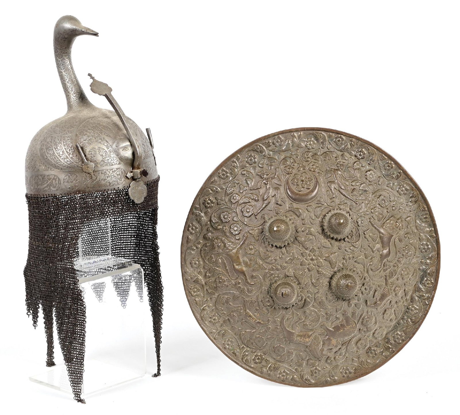 LOT OF 2: KULAH KHUD HELMET AND SHIELD.: Lot consists of (A) Kulah Khud of unusual form, with a goose element across the top of the skull, with typical incised designs of florals throughout and traces of thin koftgari work. Pair of plume