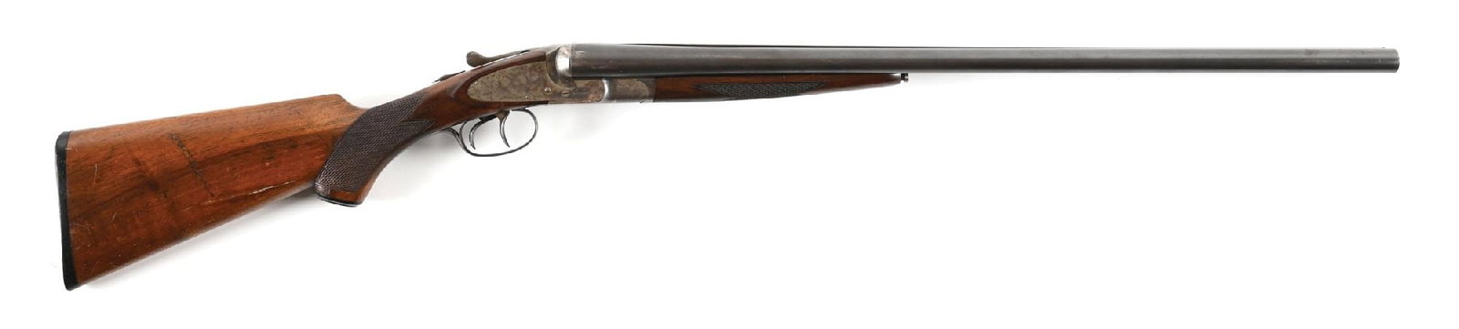 (C) L.C. SMITH FIELD GRADE SIDE BY SIDE 12 GAUGE SHOTGUN.: Circa 1915. Depressed bead front sight on a finely matted solid, narrowing, tapering rib with L.C. Smith Field grade designation over right chamber and Hunter Arms information over left. Underside of 