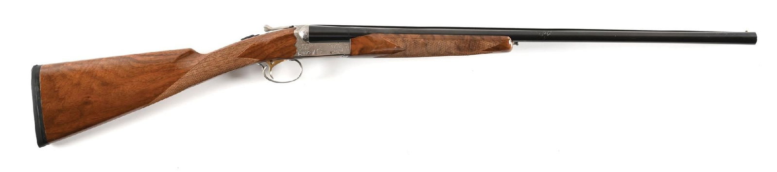 (M) SKB MODEL 385 20 BORE SIDE BY SIDE SHOTGUN.: Made in Japan. Features the engraved coin silver scalloped boxlock frame, single selective gold-washed trigger, blued barrels with matted rib, single bead front sight, and ejectors. Features a checker