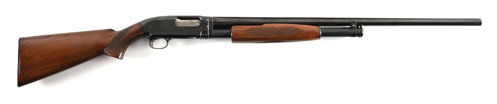 (C) DELUXE WINCHESTER MODEL 12 20 BORE SLIDE ACTION SHOTGUN WITH SOLID RIB.: Dates to 1946. Features the matted solid rib, single bead front sight, take down, blue finish, walnut stock with checkered pistol grip, Winchester black buttplate, and matching round bottom forearm.