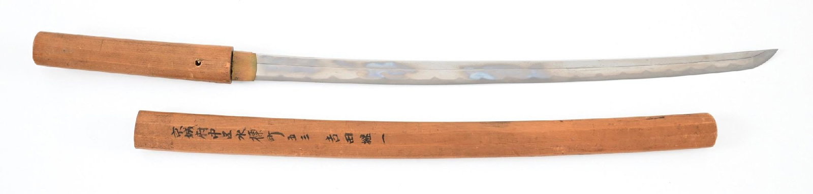 JAPANESE WAKIZASHI IN SHIRASAYA.: Approximately 53.1cm nagasa of classic shinogi zukuri form with 27mm motohaba, 11mm kasane. Ubu, mumei nakago with copper sekigane and kiri style nakagojiri. Hamon is a repeating pointed notare with