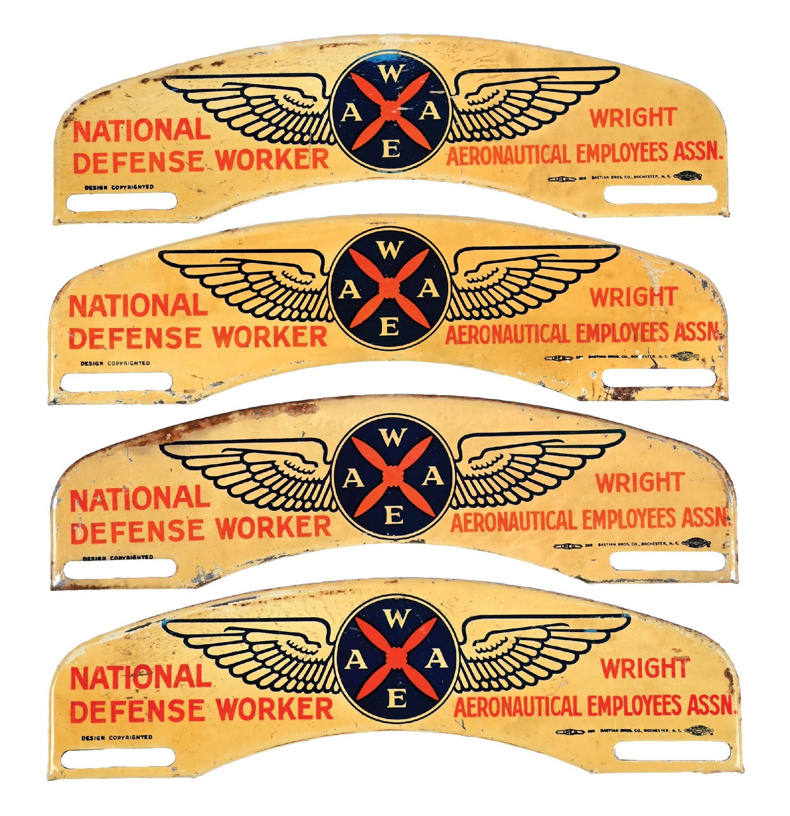 COLLECTION OF 5: NATIONAL DEFENSE WORKERS TIN LICENSE PLATE TOPPERS: Single-Sided Tin. Each Maker Marked Bastian Brothers. C. 1940s. CONDITION: Each in fair condition, all found NOS, showing moderate paper wear and light age staining, showing surface scratches and pain