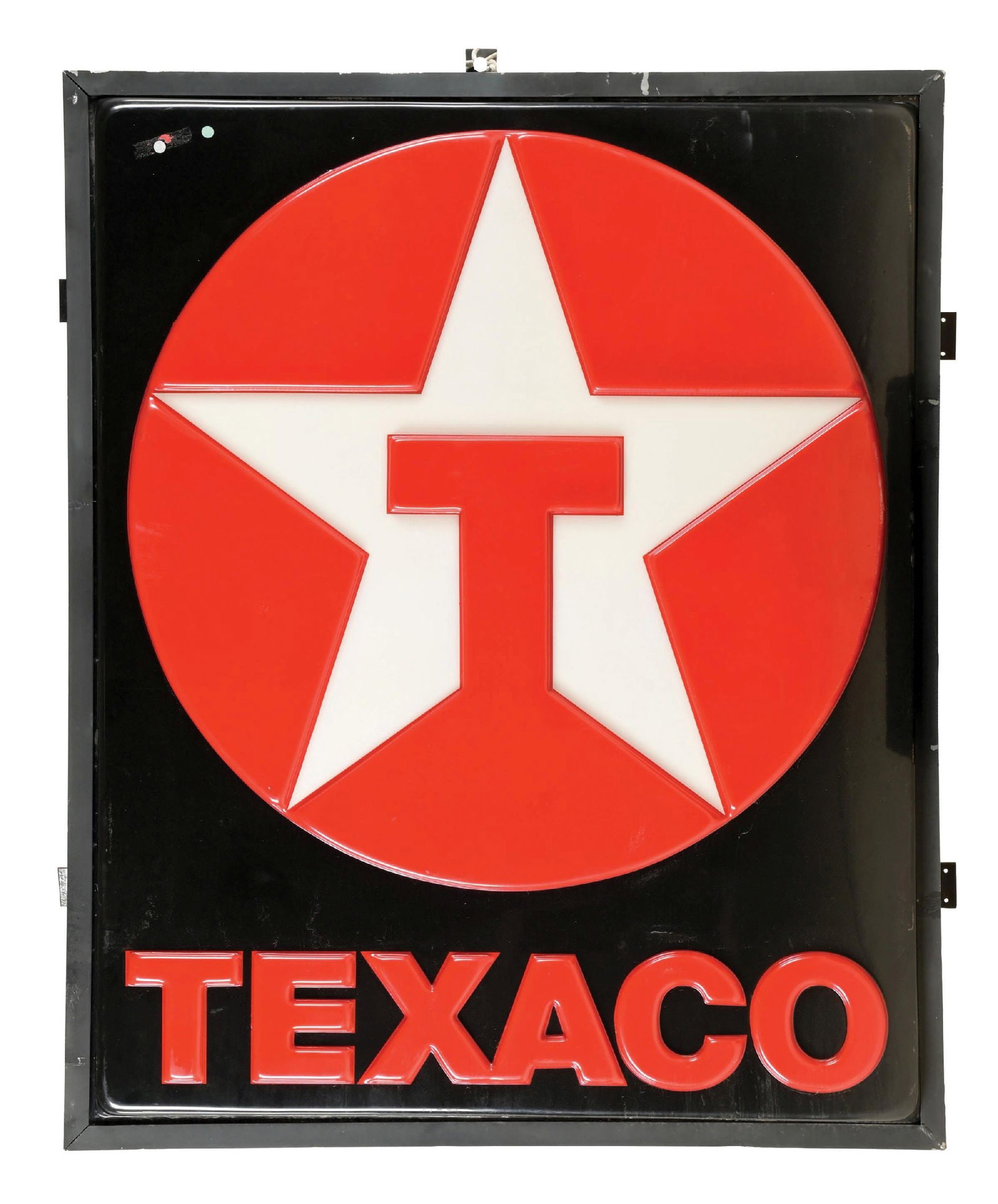 TEXACO EMBOSSED PLASTIC SERVICE STATION SIGN: One Embossed Plastic Sign mounted in its original metal framing. C. 1990s. CONDITION: Sign shows bright color and gloss throughout, with no notable areas of heavy wear or damage. Sign is mounted on th