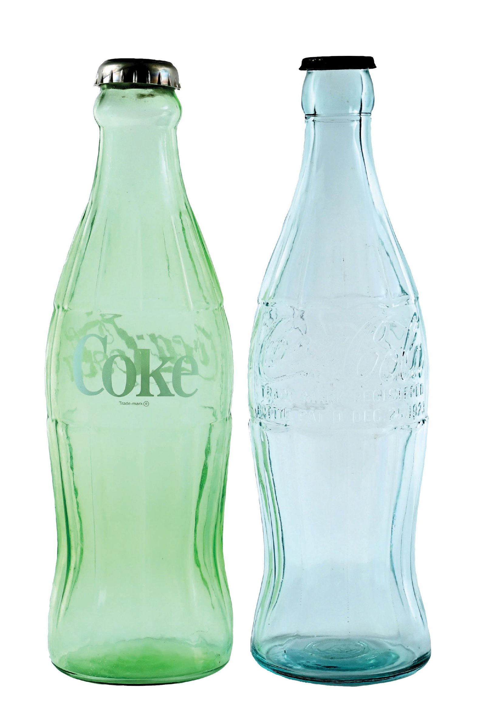 COLLECTION OF 2: COCA-COLA DISPLAY GLASS BOTTLES: A nice collection of two display bottles from Coca-Cola, including a c. 1930s embossed bottle with cap and a c. 1960s-1970 printed label bottle with plastic cap. CONDITION: Both remain clean, with no