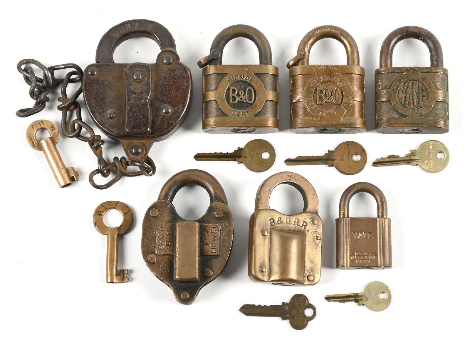 LOT OF 7: RAILROAD LOCKS: (A) A steel switch lock, incised on the shackle “WMRY S M”, “1956” incised on the reverse. The maker’s diamond logo is incised on the dust cover, along with “LANC P
