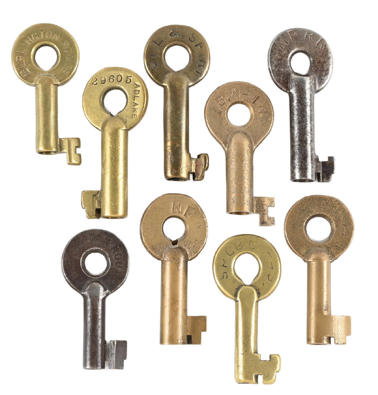 LOT OF 9: RAILROAD KEYS: (A) A bronze Adlake switch key, incised “SP CO”. Key shows heavy pocket wear. (B) Adlake bronze switch key, incised “NP” on the hilt. Light pocket wear. (C) A bronze Adlake swi