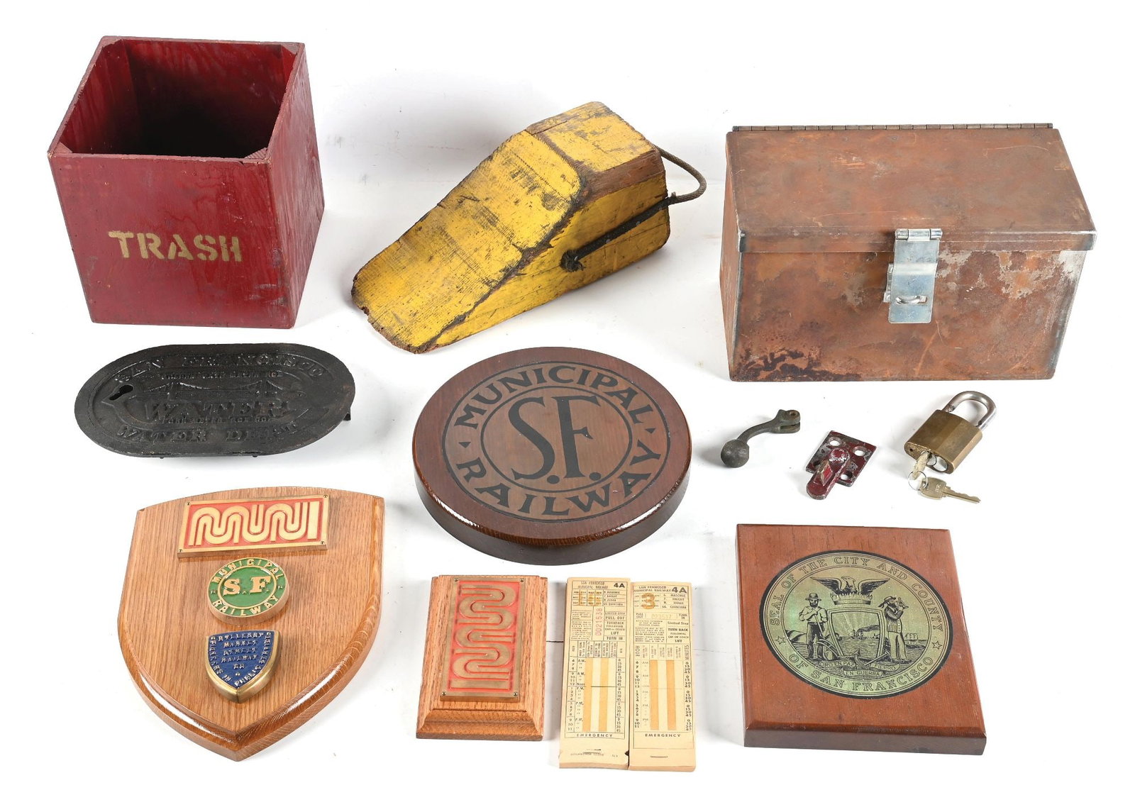 COLLECTION OF SAN FRANCISCO MUNICIPAL RAILWAY (MUNI) ITEMS: Including: four wooden plaques, two with metal medallions; a steel strongbox with some miscellaneous stickers inside, showing significant surface rust; a padlock with keys, vibroscribed