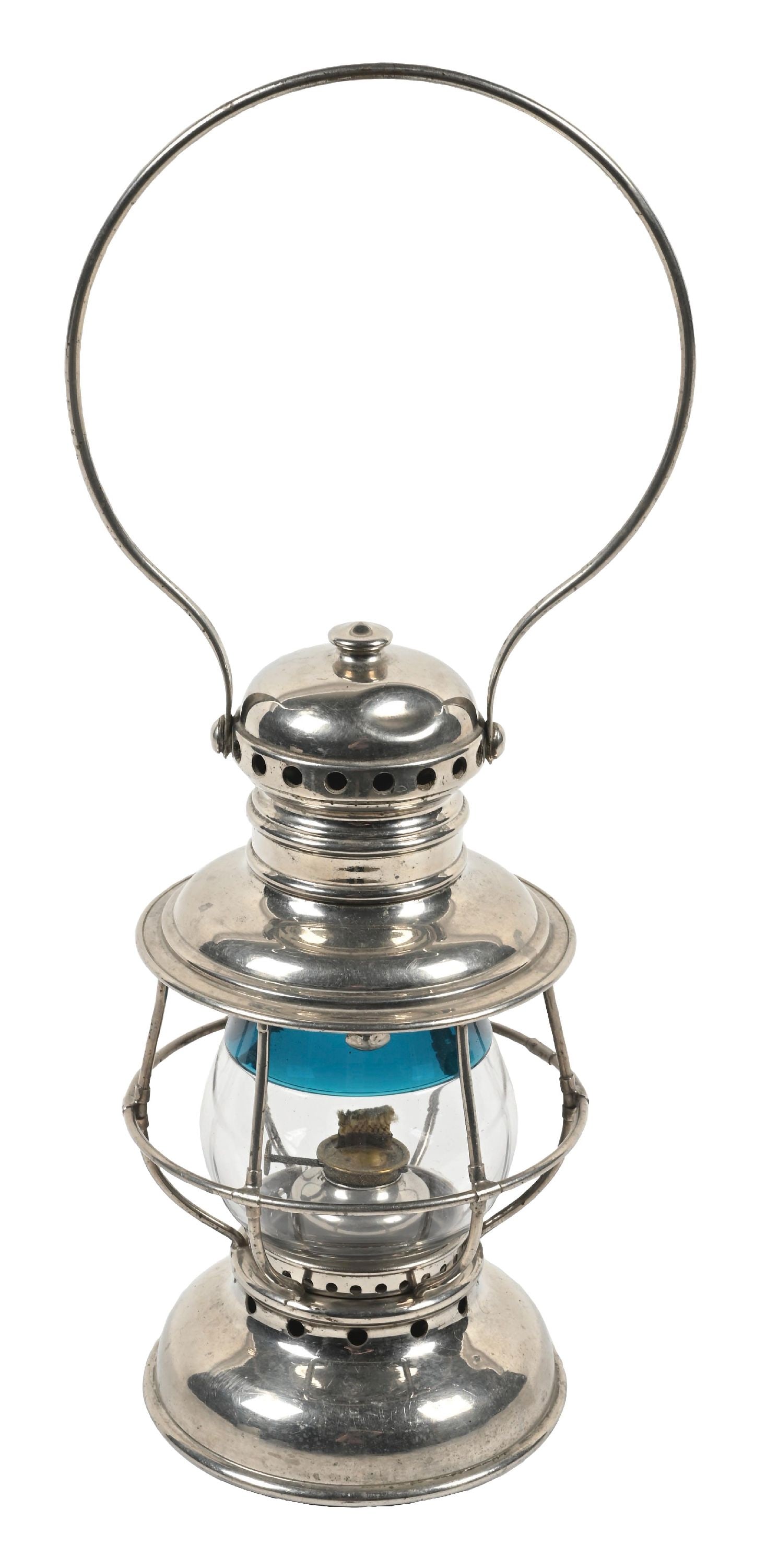 CONDUCTOR’S RAILROAD LANTERN: An Adams & Westlake “Queen” model with nickel over brass construction. The hand-blown and fused two-color globe is a very nice signal green over clear, with no signs of use. There is a