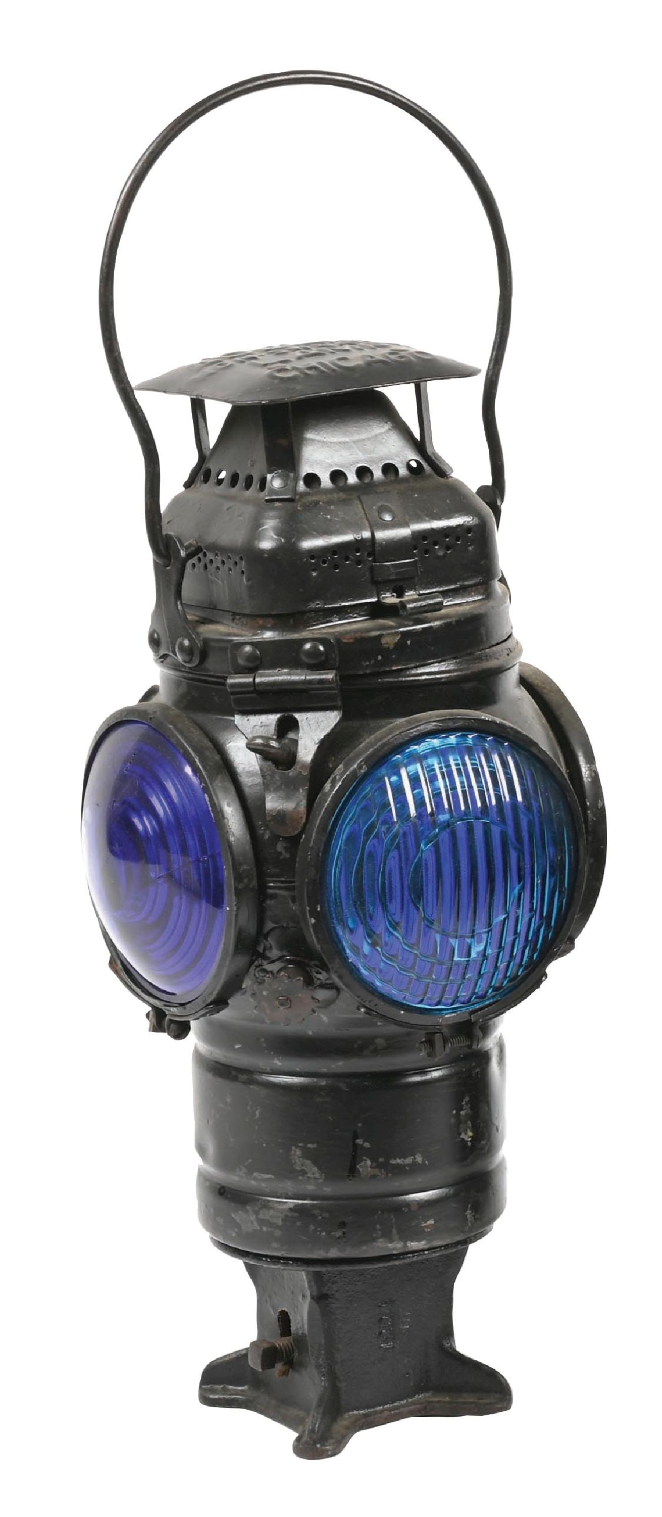 RAILROAD SQUARE-TOP SWITCH LAMP: An Adlake square-top switch lamp with no railroad markings. Fount and burner unit is intact. Lamp has two ribbed green lenses and two cobalt blue lenses. Condition: (6.0). Dimensions: 7 - 1/2" x 7 - 1