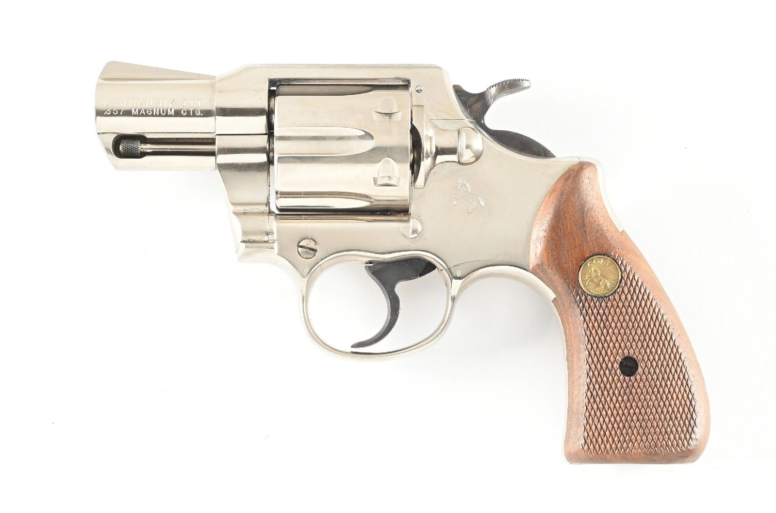 (M) COLT LAWMAN MK III .357 MAGNUM DOUBLE ACTION REVOLVER.: Dates to 1978. Built on the J-frame as was the Trooper. It sports the nickel finish, fixed sights, shrouded ejector, round butt and fitted with Colt gold medallion checkered walnut grips. CONDITION: E