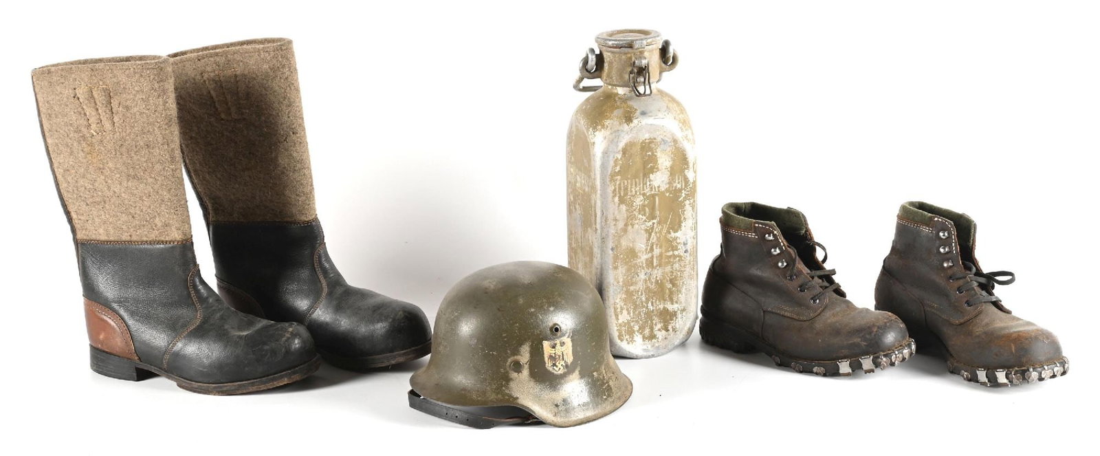 LOT OF GERMAN WWII BOOTS, HELMET, AND WATER CAN.: Lot includes an original repainted M42 helmet shell with original liner, liner band, and chinstrap. Also included is a water can, pair of winter sentry boots, and a pair of Gebirgsjaeger boots. CONDIT