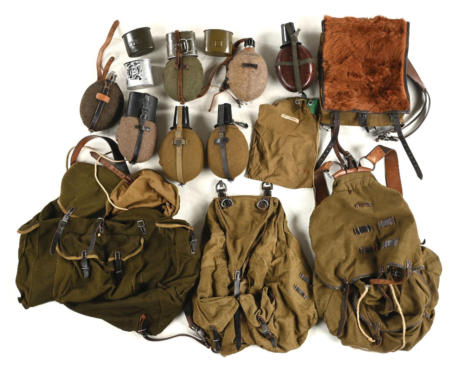 LOT OF GERMAN WWII PACKS AND CANTEENS.: Large lot of German WWII rucksacks and canteens. CONDITION: Overall very good to excellent.