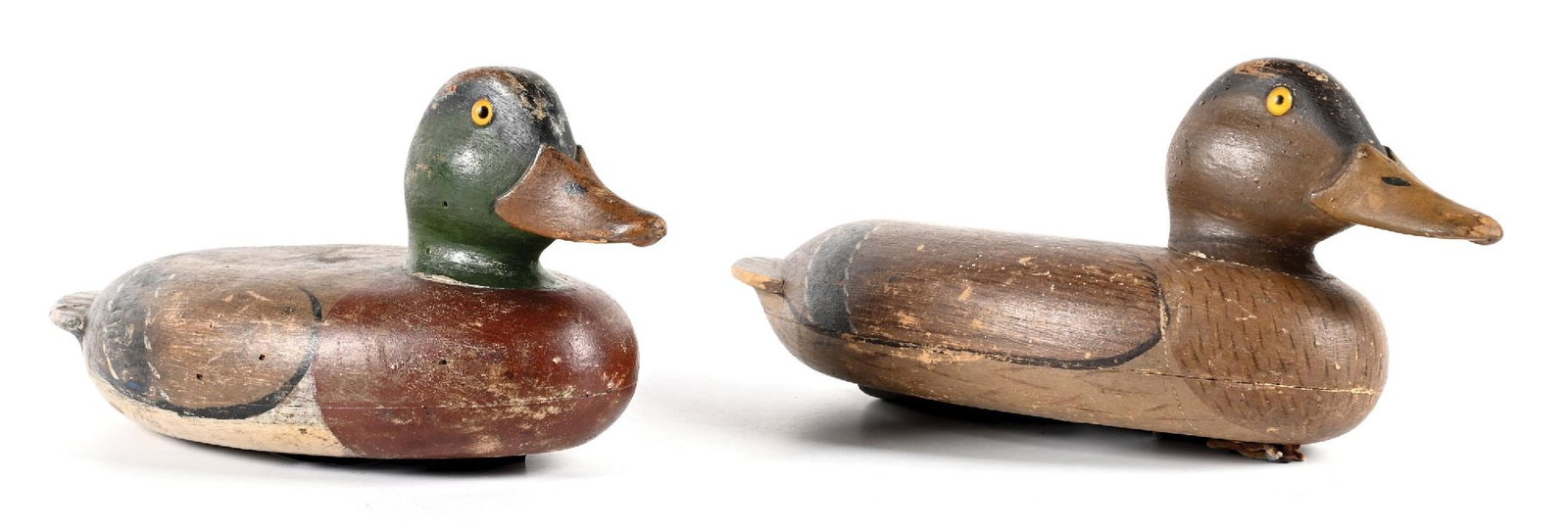 A PAIR OF VINTAGE WOODEN DUCK DECOYS: 1. BURKHARD ST. PAUL BLUEBILL DECOY WITH STAMPED WEIGHT. CONDITION: Showing heavy surface wear and paint loss from use; head reset with visible collar line; replaced eyes; original stamped weight inta