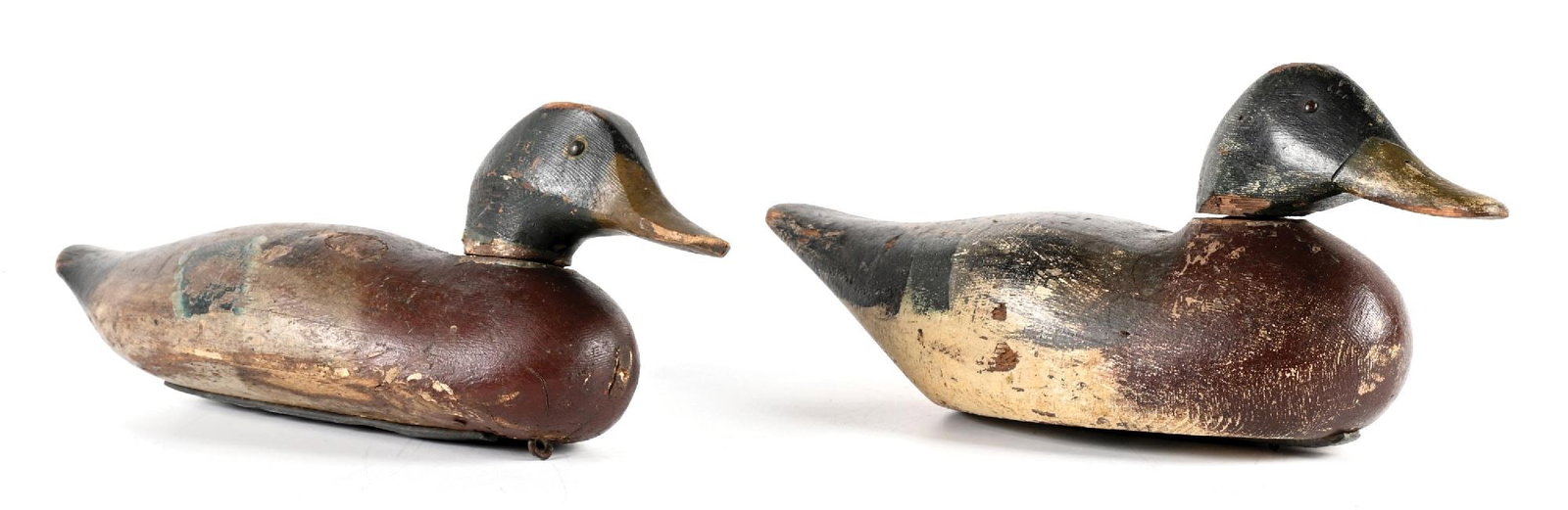 A PAIR OF VINTAGE WOODEN DUCK DECOYS: 1. EARLY 20TH CENTURY MALLARD DRAKE DECOY. CONDITION: likely Illinois River region, with carved head and iron keel weight. Retains original paint with working surface. Moderate to heavy gunning wear w
