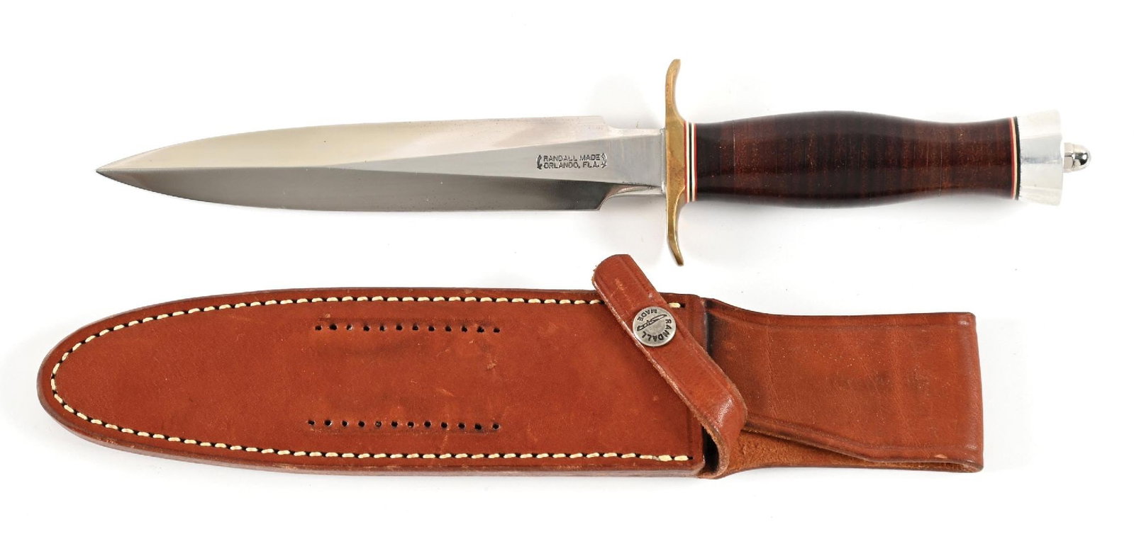 RANDALL MODEL 2-7 FIGHTING STILETTO.: Randall Model 2-7 with clip point blade marked "RANDALL MADE / ORLANDO, FL" between Randall's signature scimitars. Carbon steel construction. Blade is bright with great cross graining. Brass cross