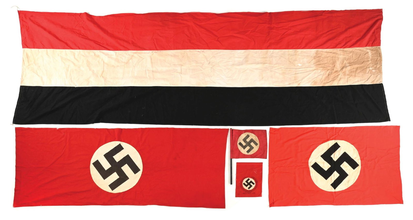 LOT OF 5: THIRD REICH AND IMPERIAL GERMAN FLAGS.: Lot of 5 Imperial and Third Reich German flags. Largest Third Reich flag measures 72" x 43", smallest measures 12" x 9". (A) Imperial German doubled-sided flag measures 128" x 43" with 2 one inch hole