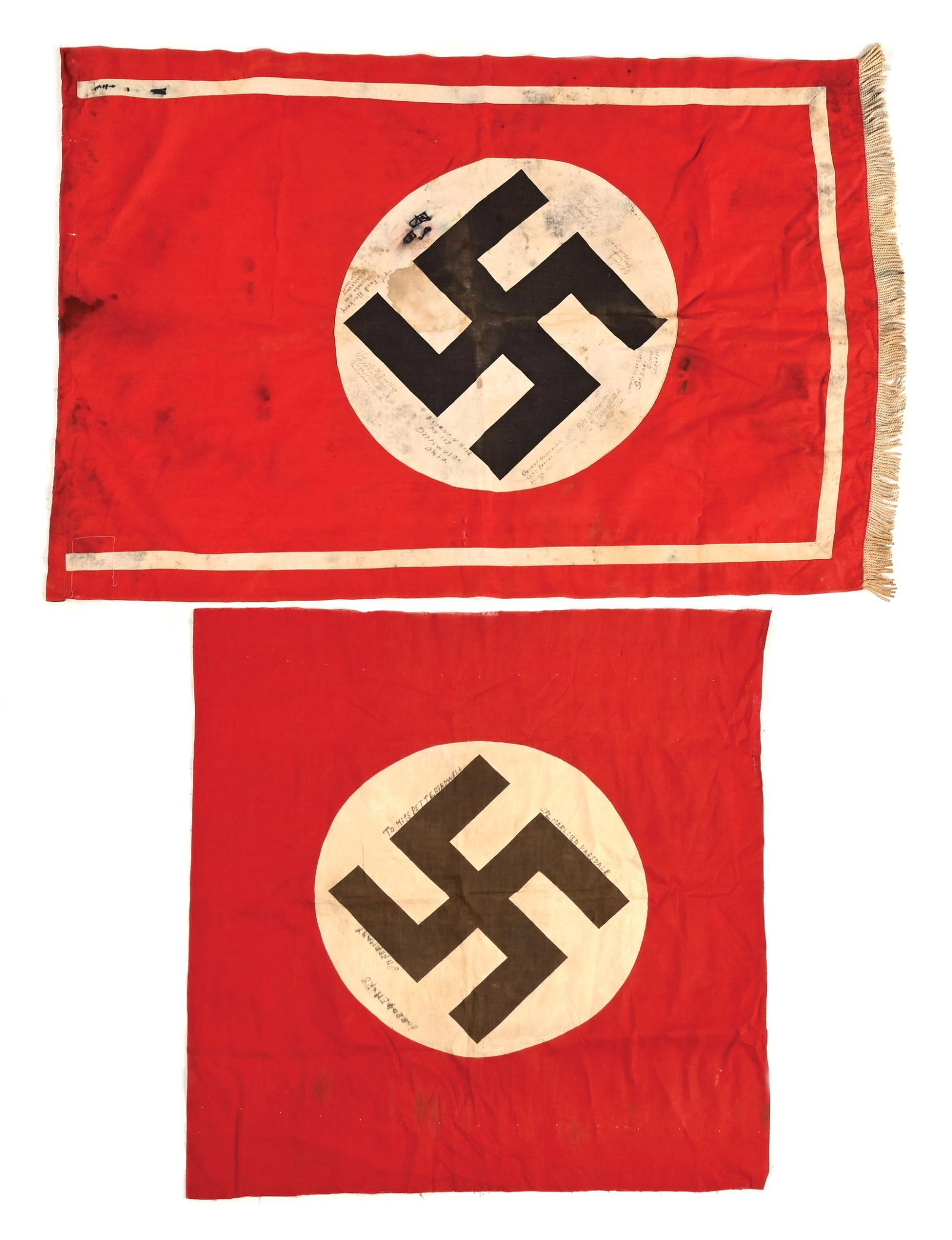 LOT OF 2: THIRD REICH FLAGS CAPTURED AND SIGNED BY US SERVICEMEN.: Lot contains 2 Third Reich NSDAP flags signed by US veterans. (A) Single-sided NSDAP podium banner measures 45" x 30" with heavy staining, 2" tear, and veteran names/ rank/ home locations (unit unknow