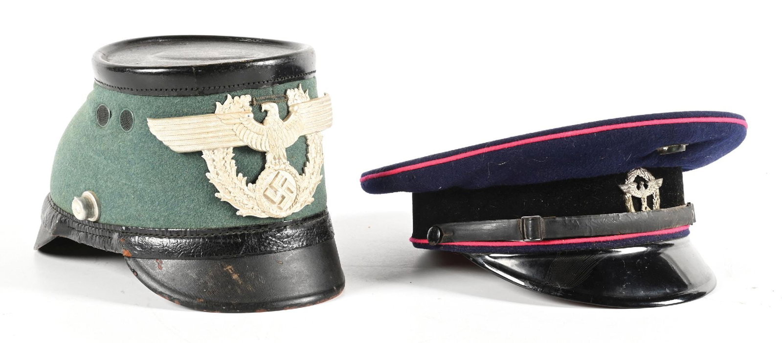 LOT OF 2: THIRD REICH POLIZEI SHAKO AND REICHSBAHN VISOR CAP.: Lot contains: (A) Third Reich Polizei Tschako missing its chinstrap and cockade. Field gray body exhibits very light staining, visor has light to moderate wear, front shield is correctly attached, and