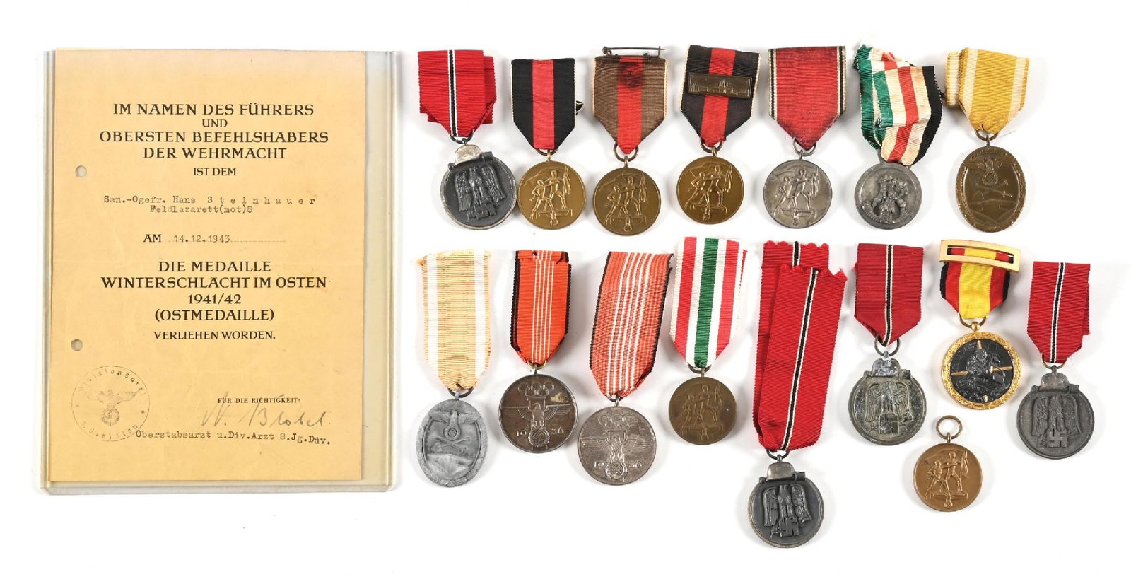 LOT OF GERMAN WWII CAMPAIGN AWARDS.: Lot of German WWII campaign awards. Lot includes Ost Front, 1938, Westwall, North Africa, and also 1936 Olympic games medals. An Ostfront award document is also included. CONDITION: Overall very good.
