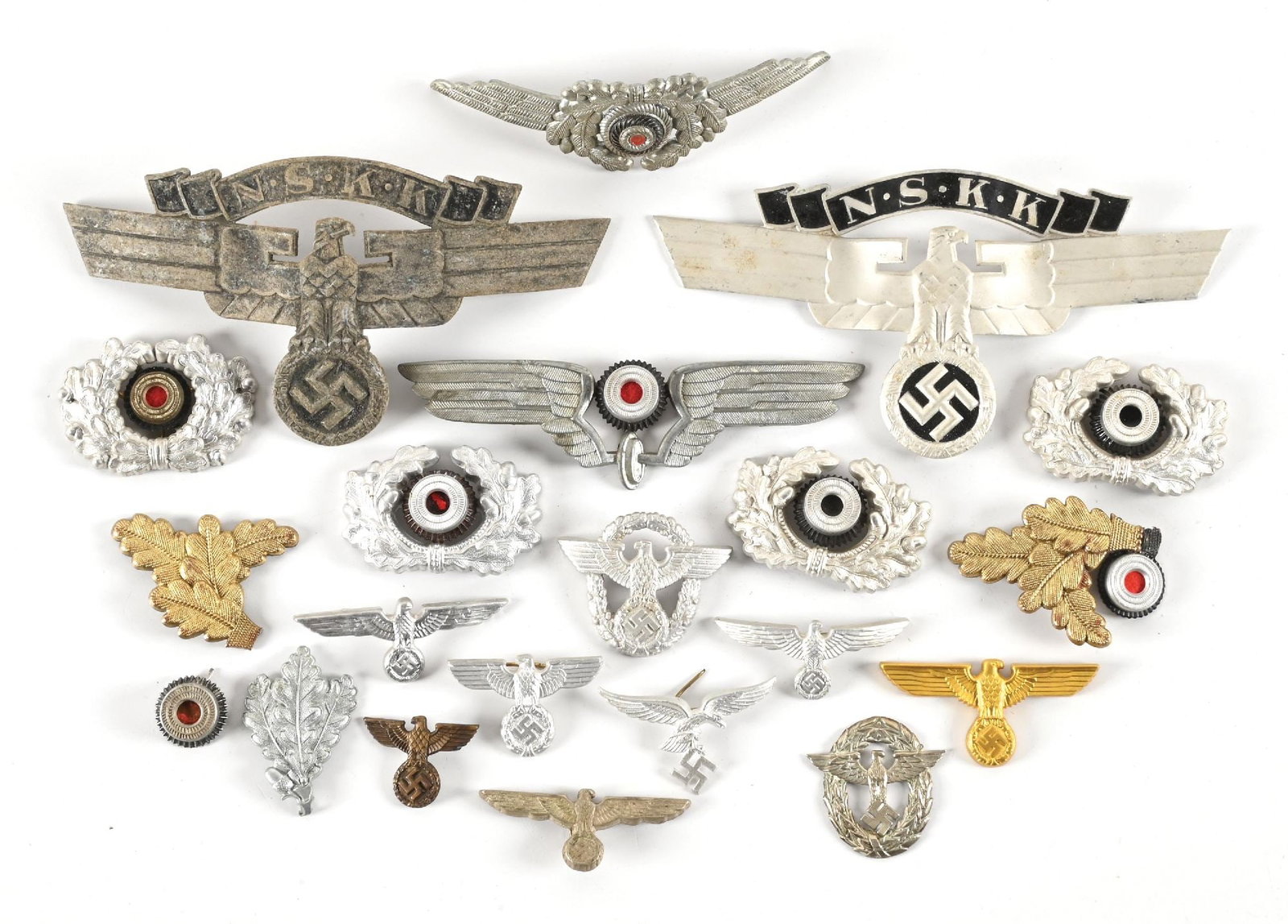 LOT OF THIRD REICH HEADGEAR INSIGNIA.: Lot of Third Reich headgear insignia. Lot includes NSKK, Polizei, Heer, and Luftwaffe cap insignia. CONDITION: Overall very good.