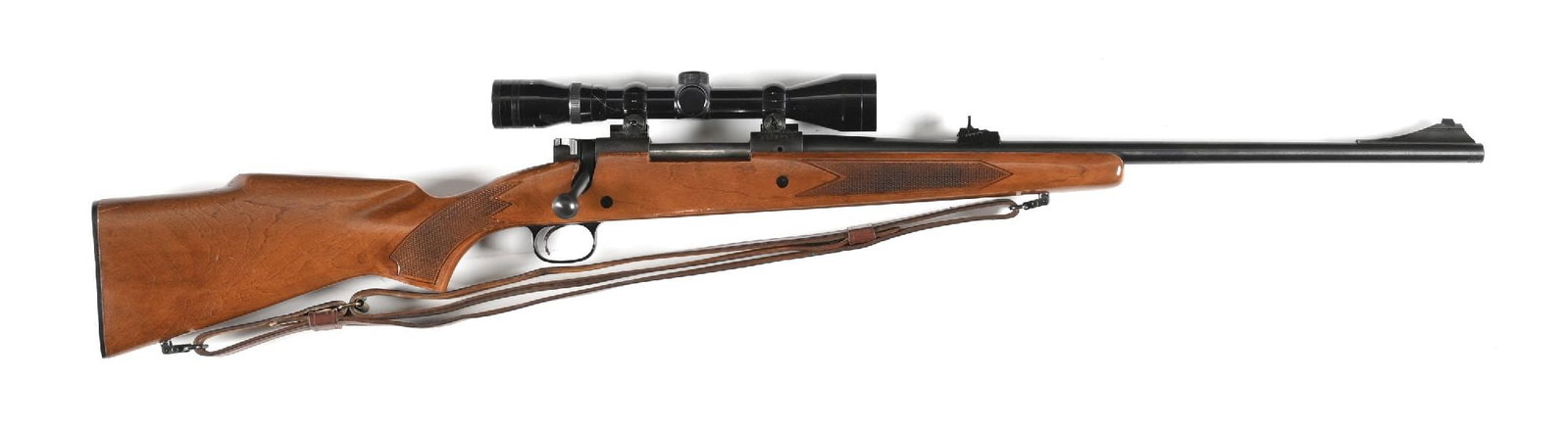 (C) WINCHESTER MODEL 670A BOLT ACTION RIFLE IN .243 WINCHESTER: Only produced from 1967 through 1973. Standard features include the blue finish, dovetailed bead on ramp front sight, adjustable rear barrel sight and sporting a Tasco 4x40 scope. The stock features a