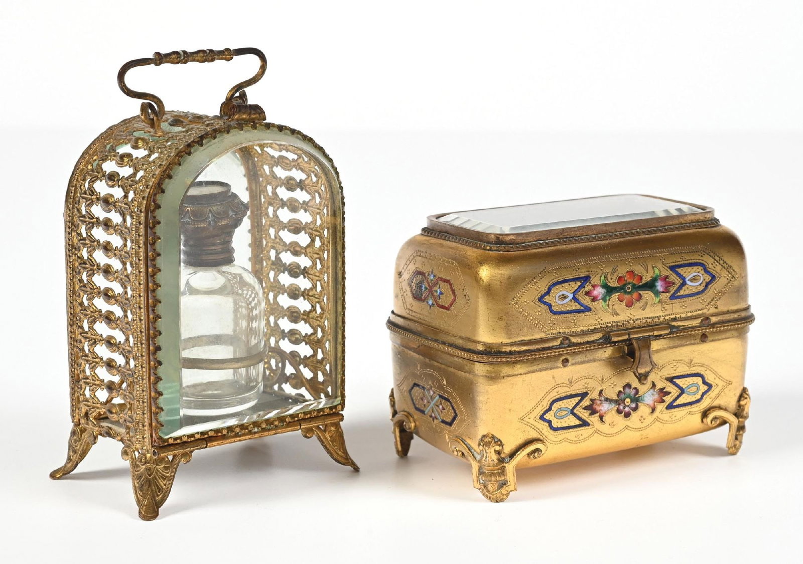 LOT OF 2: GILT BRONZE PERFUME CASKETS: C. 1800s. (A) A brass-hinged perfume vanity box with a clear-glass lid and two perfumes. The purple velvet interior shows minor wear and tear on the threading, but otherwise appears to be in fantastic