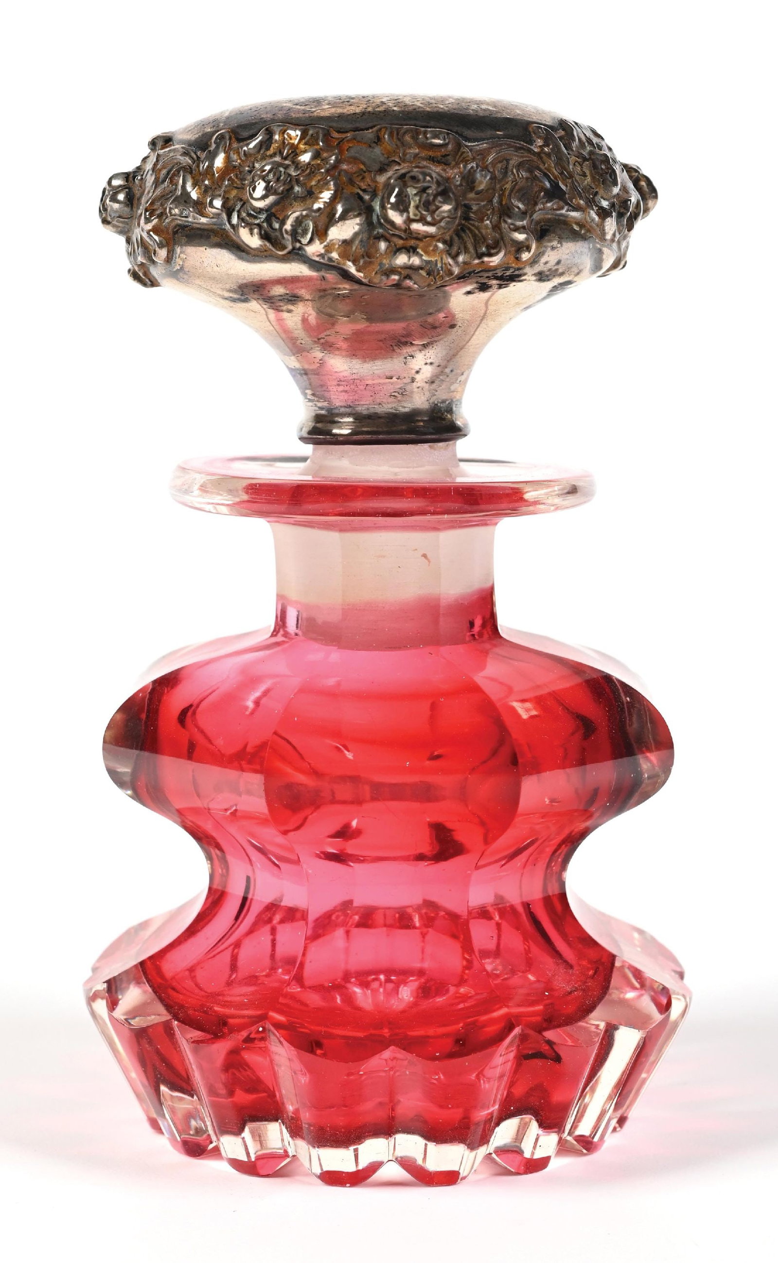 LARGE HEAVY CASED CRANBERRY GLASS PERFUME BOTTLE: C. 1800s-1900s. A unique large and heavy cranberry glass perfume featuring a cut-to-clear design. The ornate Gorham silver top is marked sterling with an ornate pattern around the stopper edges. The g