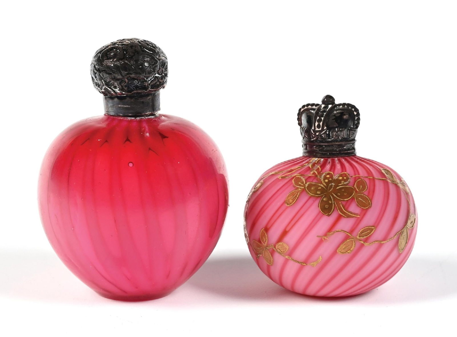 LOT OF 2: CRANBERRY ART GLASS PERFUME BOTTLES: C. 1900s. (A) A spectacular cranberry glass scent bottle with a round globular body made of cranberry glass, the glass has a subtle drape pattern, with a graduated red to pink shading. The perfume is 