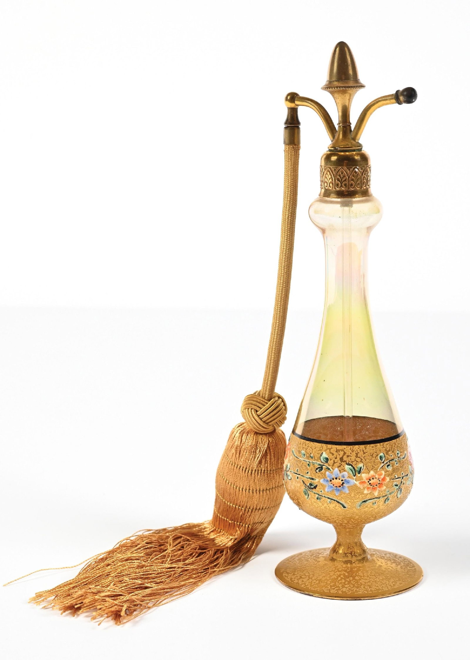DEVILBISS IRIDESCENT GOLD TALL PERFUME WITH FLORALS INCLUDING ATOMIZER: C. 1920s. A spectacular signed DeVilbiss perfume atomizer with heavy gold-encrusted ice-chipped textured pattern and hand-painted enamel flowers. The perfume comes in an iridescent amber bottle with g