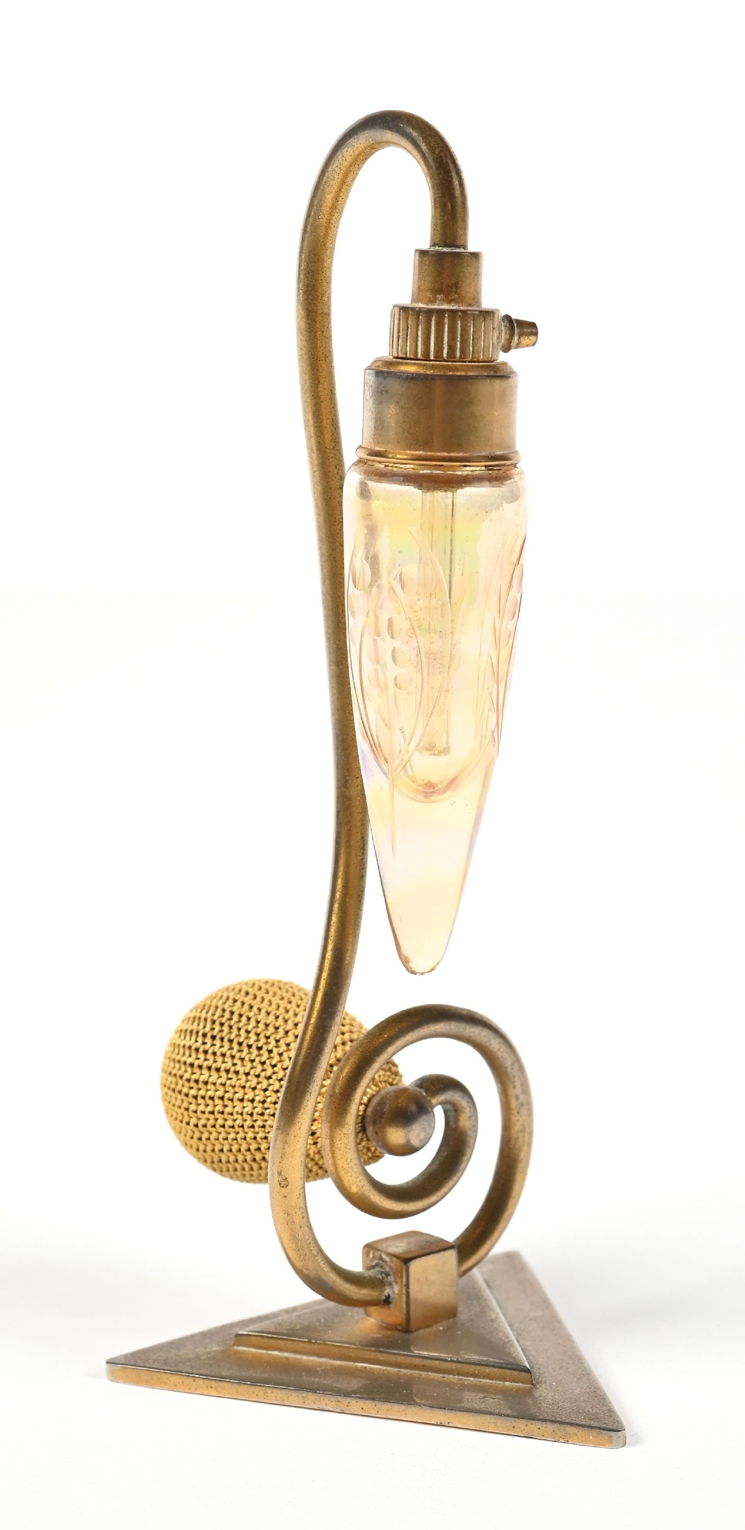 DEVILBISS DEBUTANTE ART DECO AMBER PERFUME WITH ATOMIZER: C. 1920s. A fantastic, rare Art Deco DeVilbiss Debutante series #1013. The bottle features an amber iridescent glass bottle with a floral etching pattern. The atomizer is held by a gold-toned metal st