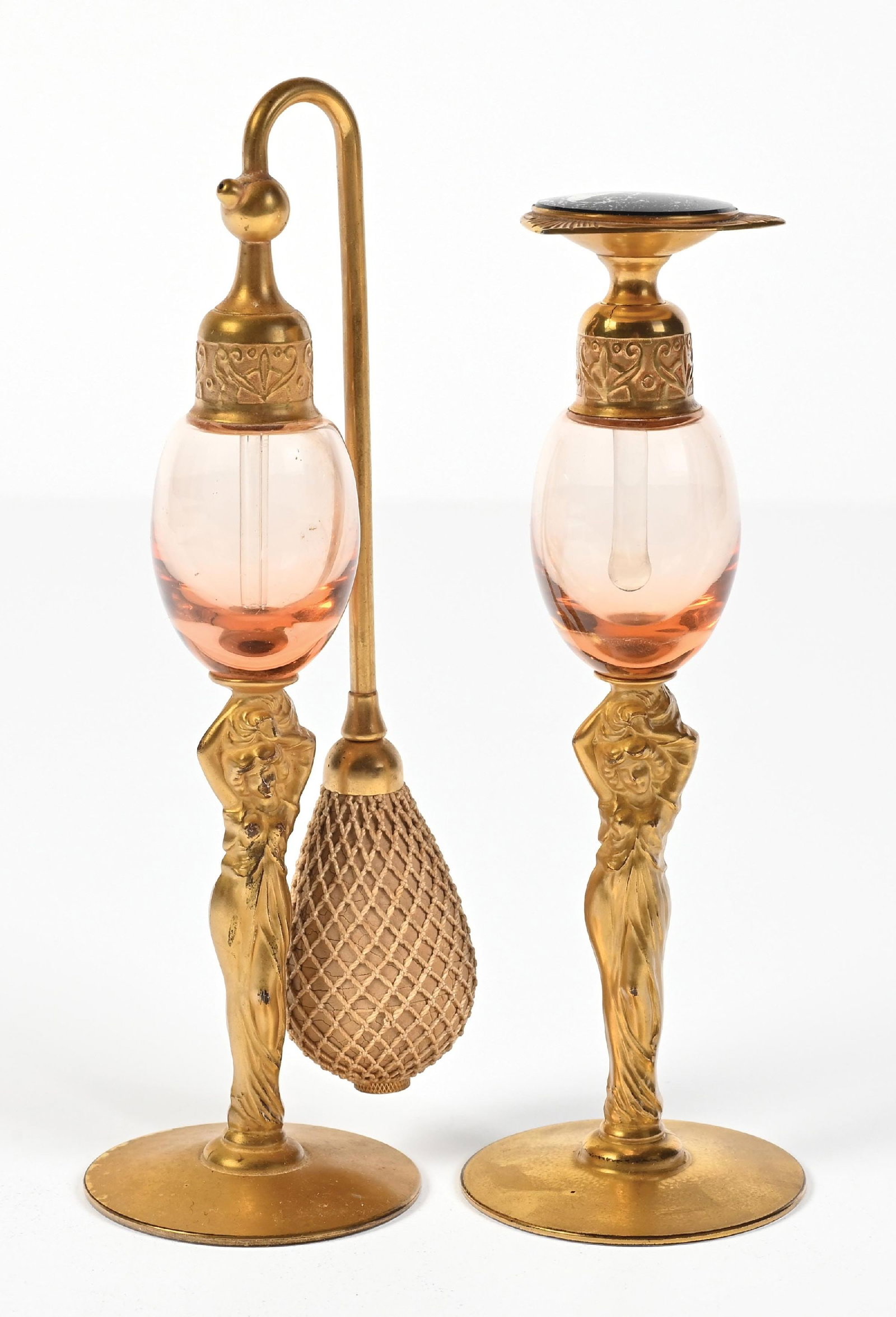 LOT OF 2: DEVILBISS ART NOUVEAU LADY STEM PINK GLASS PERFUMES, 1 PUMP & 1 ATOMIZER: C. 1928. Art Nouveau signed DeVilbiss perfume atomizer and dip tube. The glass bodies feature a pink bowl and gold-toned Art Nouveau lady stems. The perfumes feature gold-toned hardware. The atomizer 