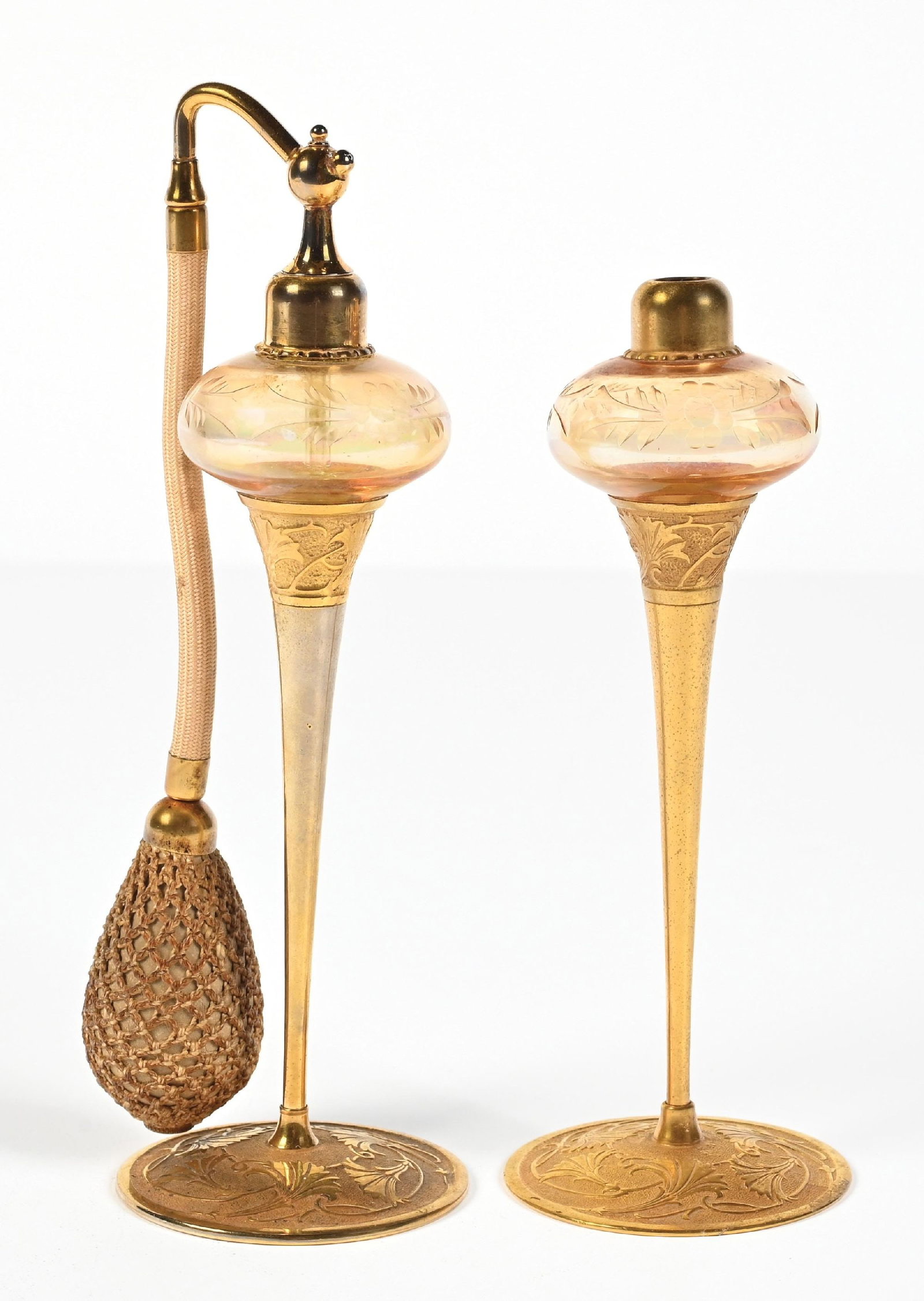 LOT OF 2: DEVILBISS PERFUMES BRASS BASE AND GOLD GLASS ORBITAL BODIES WITH ETCHED FLORAL DESIGNS: C. 1920s. Gorgeous pair of DeVilbiss iridescent gold-toned perfumes. The design features a gold orbital glass body with an etched floral design on slender gold floral brass stems. Both glass globes ap