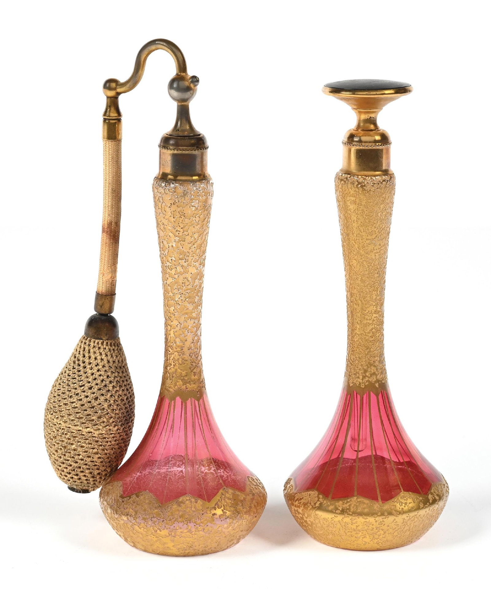 LOT OF 2: DEVILBISS CRANBERRY PERFUMES WITH GOLD ENCRUSTED DESIGN & ATOMIZERS: C. 1920s. A pair of beautiful, signed DeVilbiss cranberry glass perfume atomizers featuring a heavy gold-encrusted "ice-chipped" texture with Art Deco patterning. Typical wear anticipated with age, pu