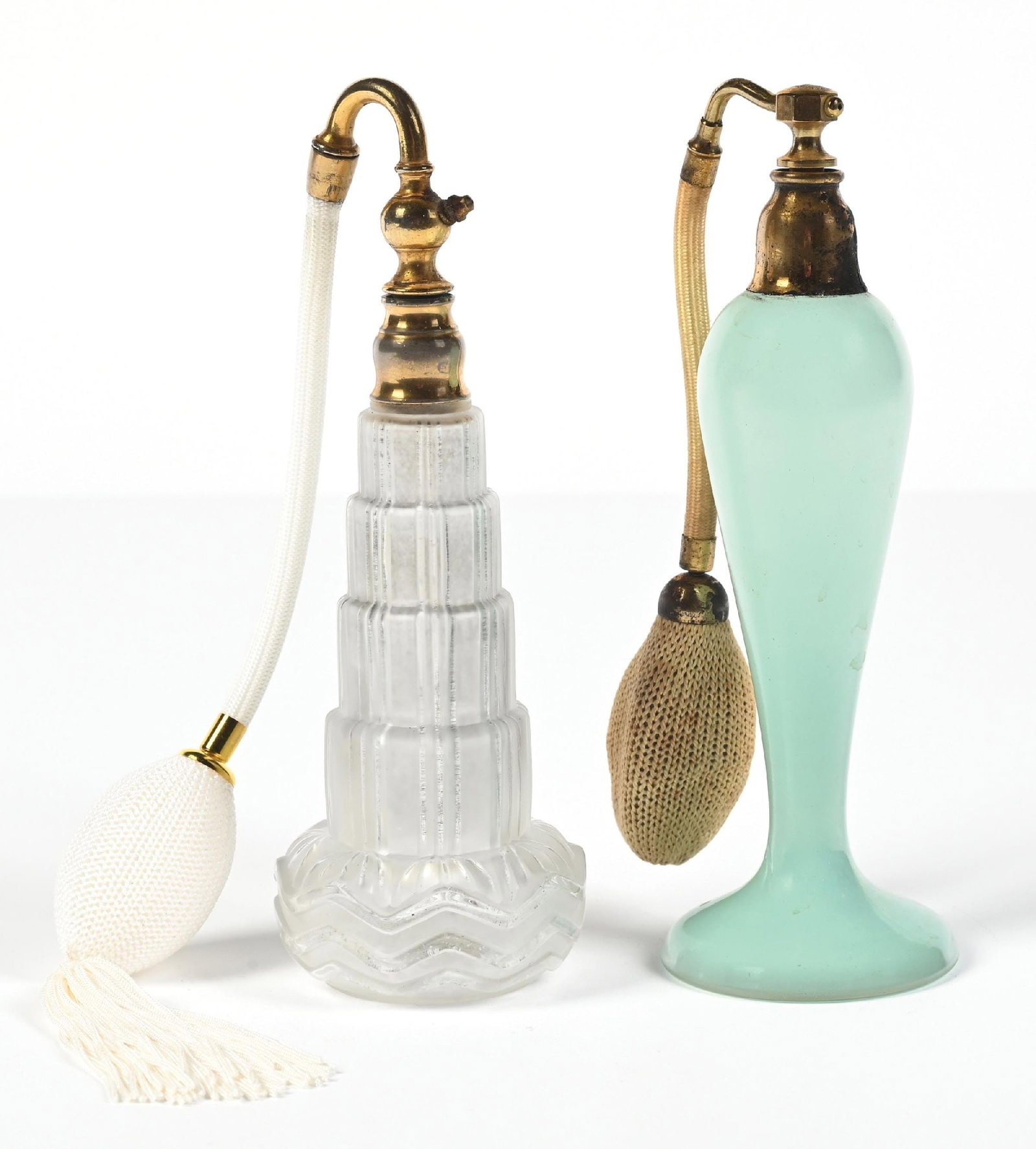 LOT OF 2: FROSTED & SEAFOAM PERFUMES WITH ATOMIZERS: C. 1900s. (A) A beautiful French frosted clear glass perfume atomizer bottle in an empire style ribbed glass body and a waved, scalloped base and including a white hose with a functional white