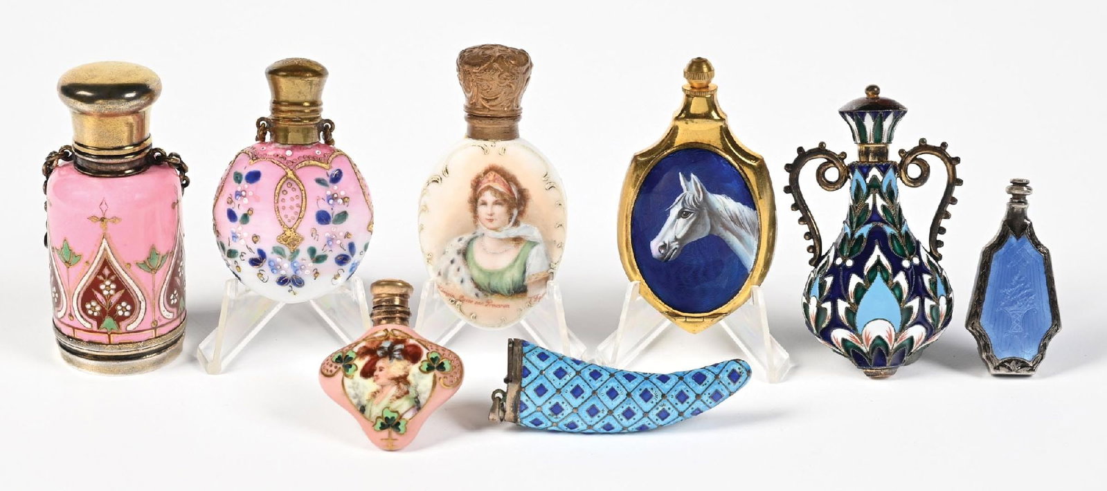 LARGE LOT OF ENAMEL PERFUME BOTTLES: C. 1800s. A collection of eight highly intricate and enameled perfumes with mild enamel fading but in spectacular condition. Largest: 1" D. x 2 - 3/4". Condition: 400 Dimensions: (Excellent).