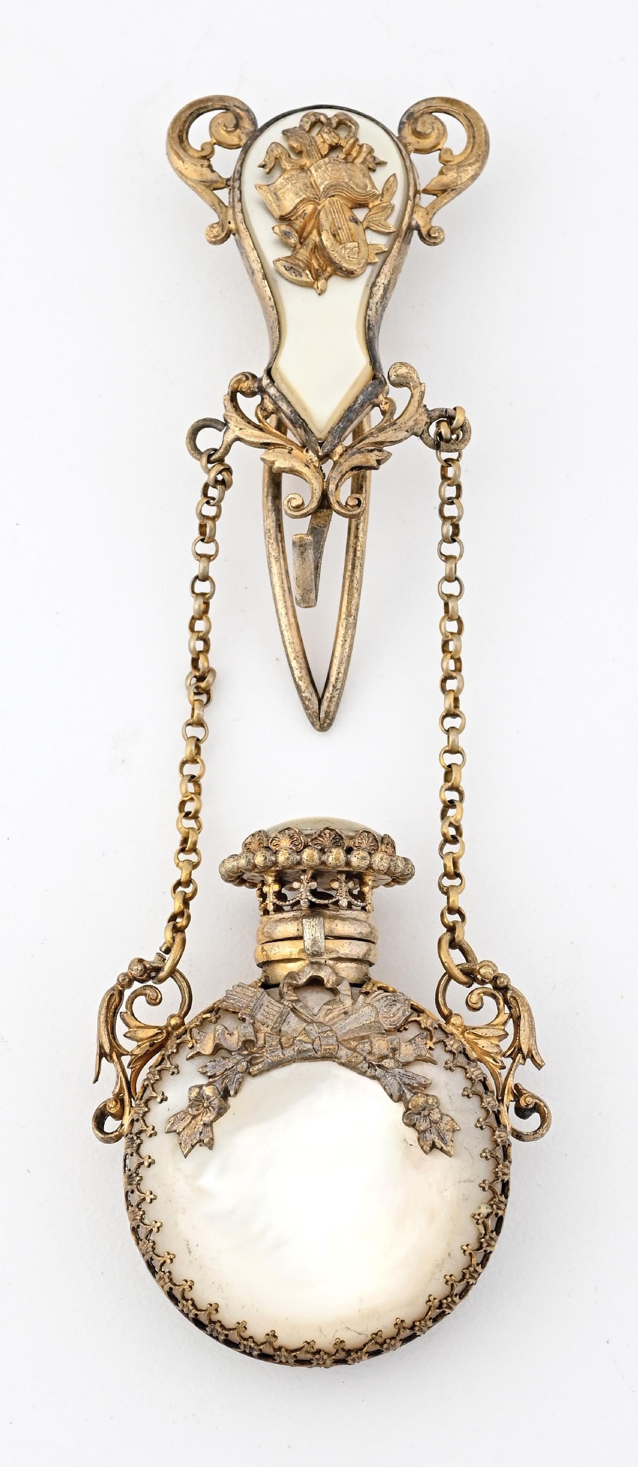 FRENCH MOTHER OF PEARL CHATELAINE PERFUME BOTTLE: C. 1800s. A stunning ornate mother of pearl gold-toned perfume châtelaine. It is in wonderful condition with a natural patina. 2" x 5". Condition: 200 Dimensions: (Excellent).