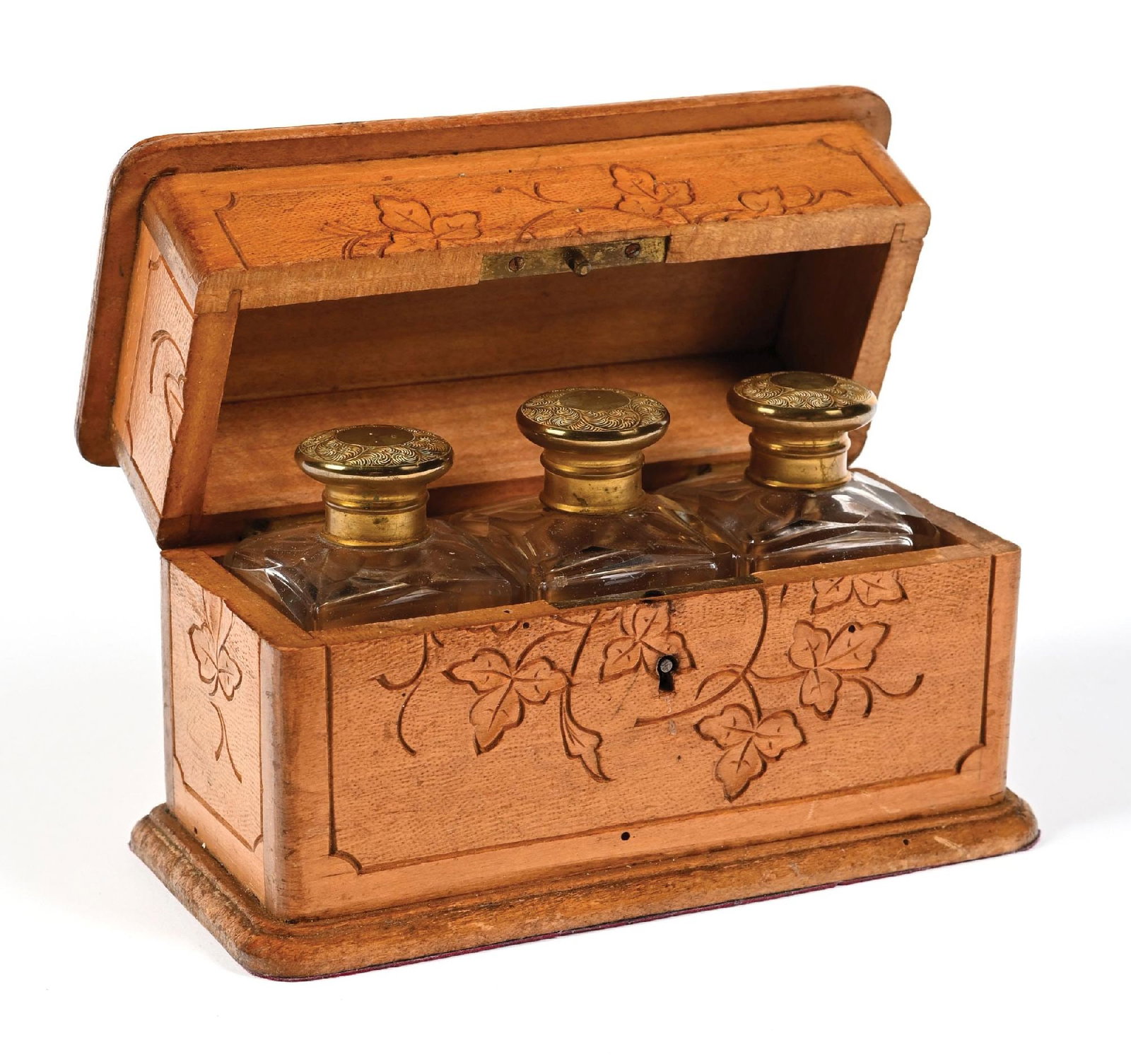 FRENCH WOODEN PERFUME BOTTLE CASKET: C. 1800s. A charming rectangular wooden perfume caddy with three gold-toned screw-topped clear glass perfumes. The exterior of the perfume casket features foliage carvings and an intricate, beautiful