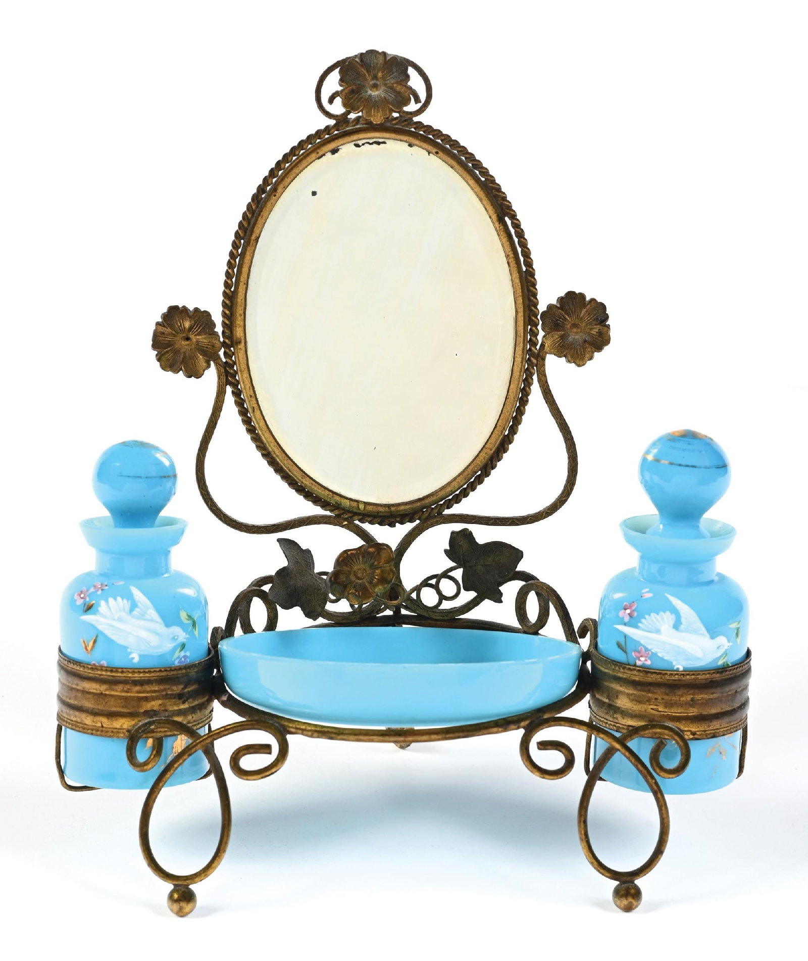 FRENCH PALAIS ROYAL BLUE OPALINE VANITY SET: C. 1800s. A brass perfume vanity set with significant patina, featuring a blue opaline trinket tray and two large blue opaline perfume bottles, with detailed bird-and-leaf enamel patterning. There is 