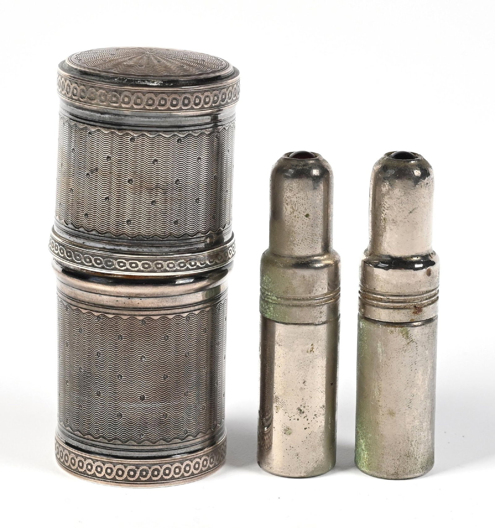 LOT OF 3: FRENCH SILVER/GILT 3 SCENT BOTTLE & PERFUME BOTTLES IN METAL CONTAINER: C. 1800s. A collection of three travel-sized perfumes. The largest silver container is 950 French fine silver (weighing 41.77 grams) and houses three glass perfumes with cut-glass lids; presents with 