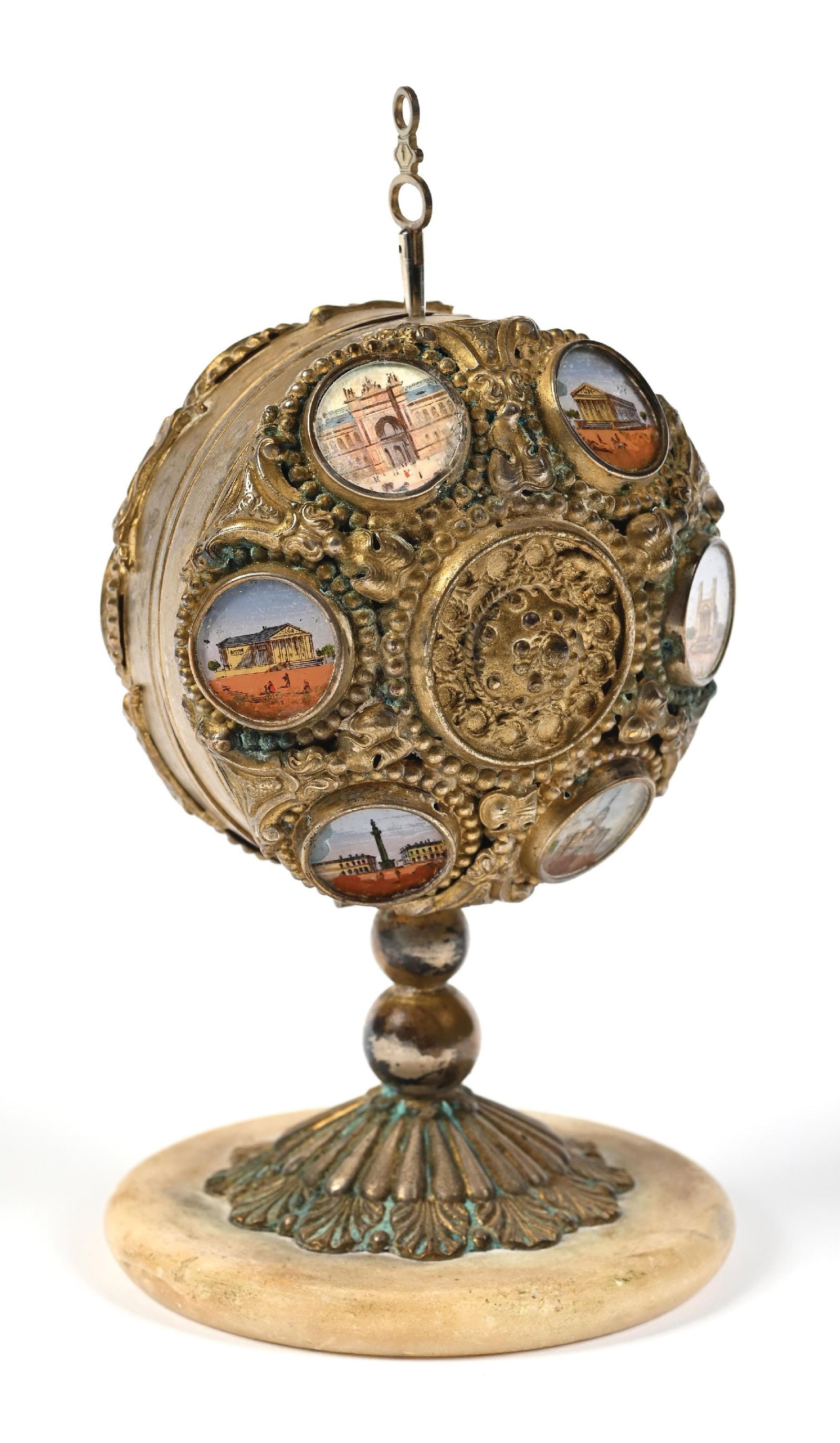 ORNATE PALAIS ROYAL BRASS PERFUME BOTTLE SET: C. 1880s. A stunning Palais Royal mechanical caddy, crafted from brass and with intricate patterning, set with 12 small circular miniature watercolor hand-painted medallions featuring European landmar