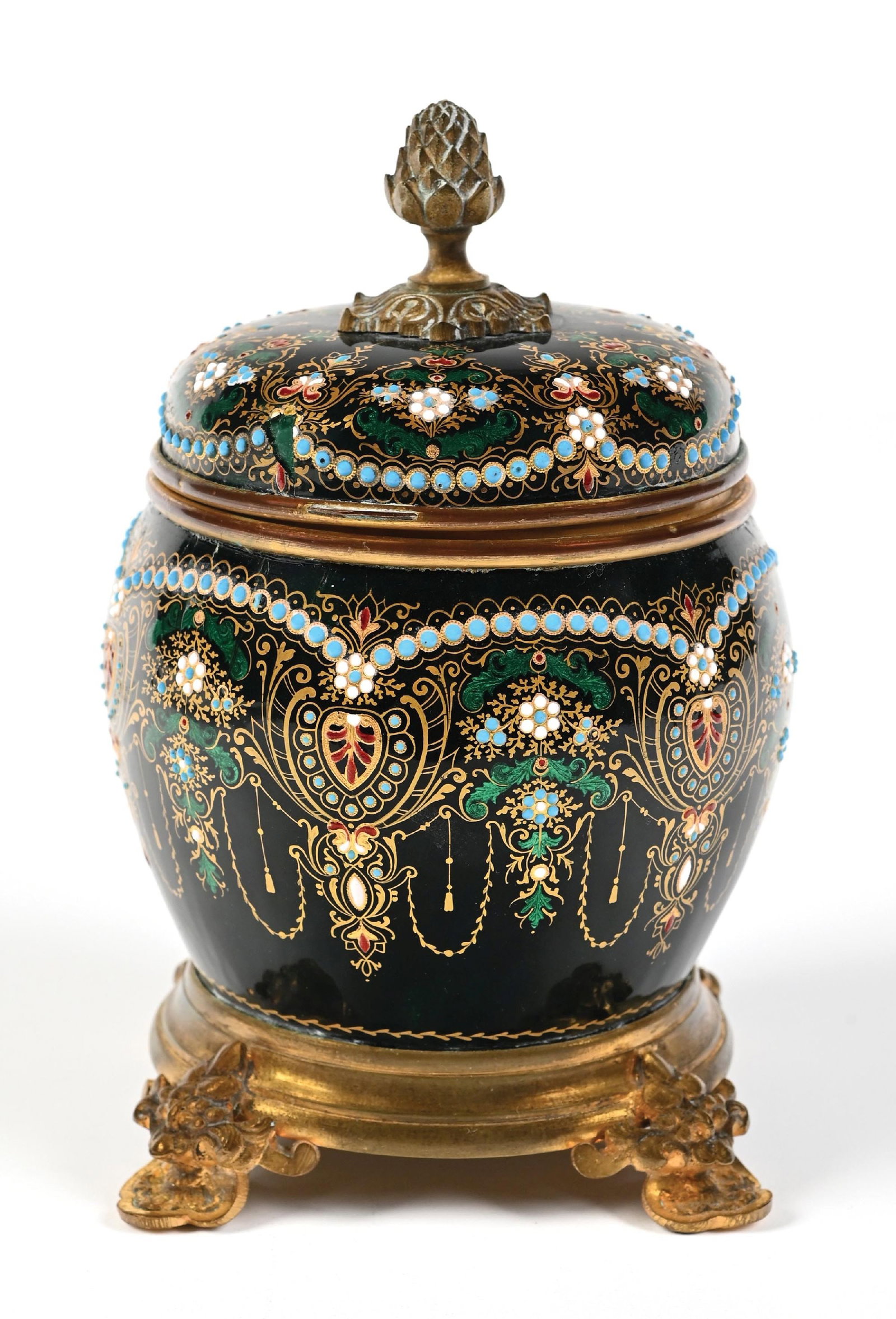 ORNATE FRENCH BLACK PERFUME CADDY WITH 4 PERFUMES AND MULTI-COLORED BEADED ACCENTS: C. 1900s. This attractive perfume caddy features a rounded, urn-like body of very deep green glass. The exterior is heavily adorned with intricate enamelwork, including turquoise beaded patterns, foli