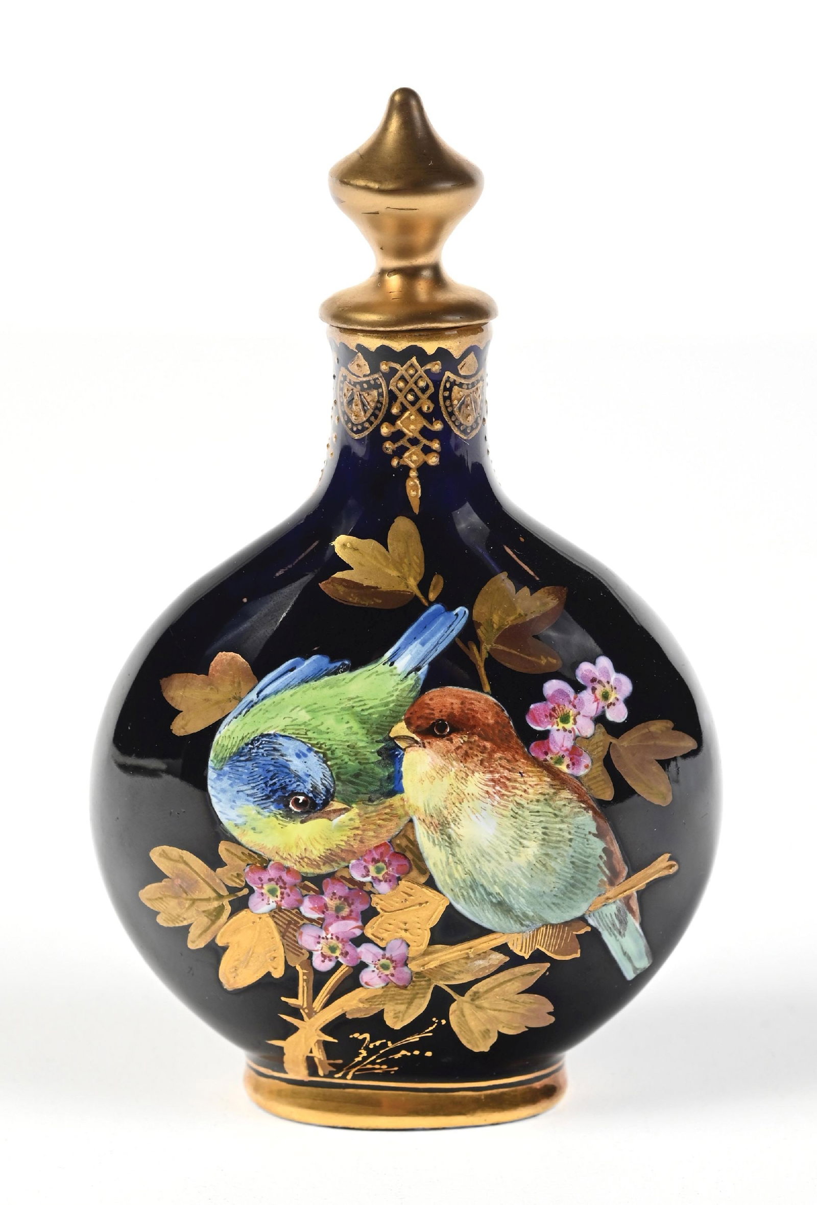 COALPORT PERFUME BOTTLE FEATURING HAND-PAINTED BIRD MOTIF: C. 1800s. A signed Coalport round porcelain perfume bottle with amazing hand painted enamel birds and floral designs on the cobalt blue body of the perfume. The perfume is in great condition. 3" x 5".